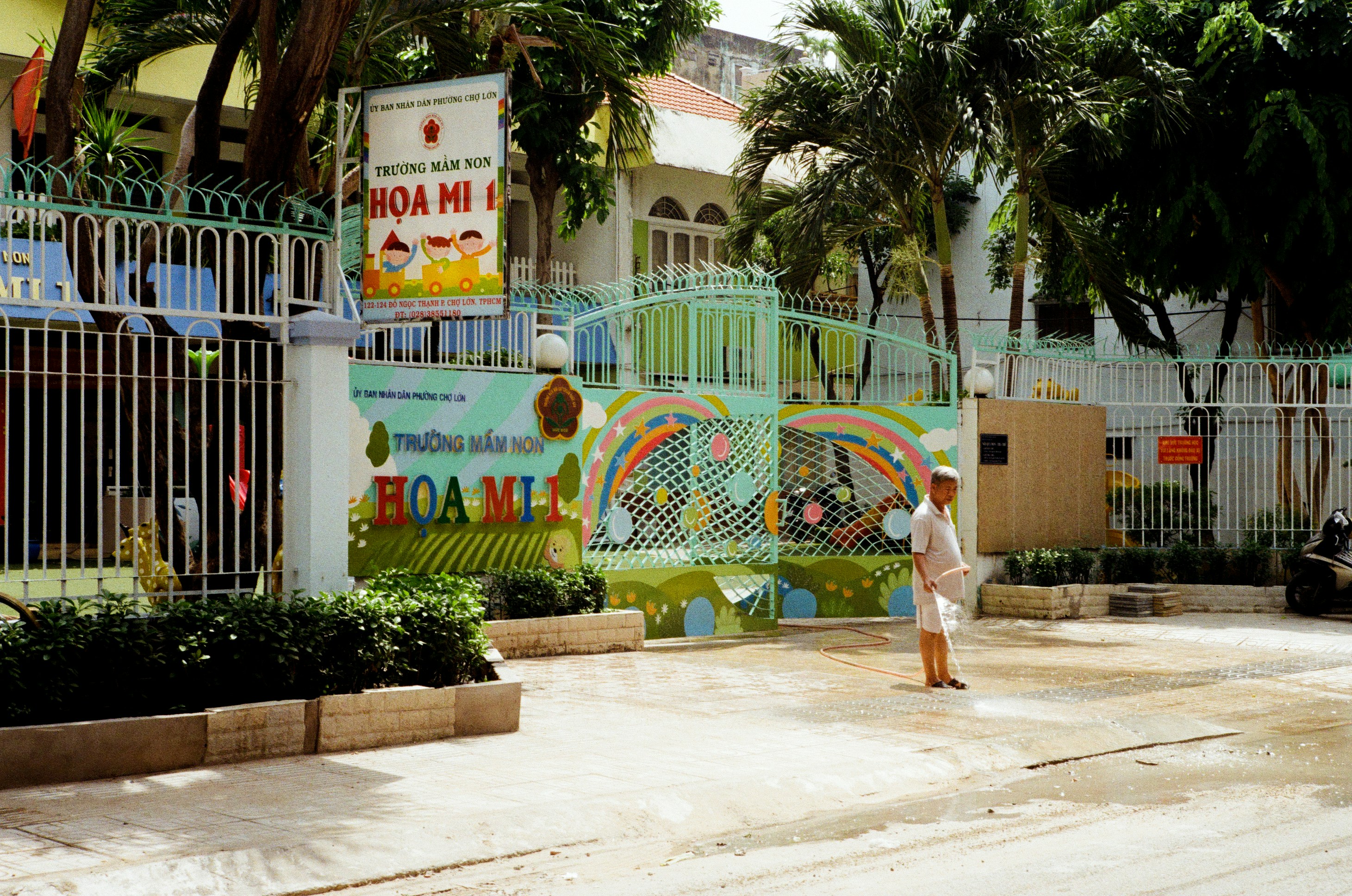 Entrance to a colorful kindergarten building with a person