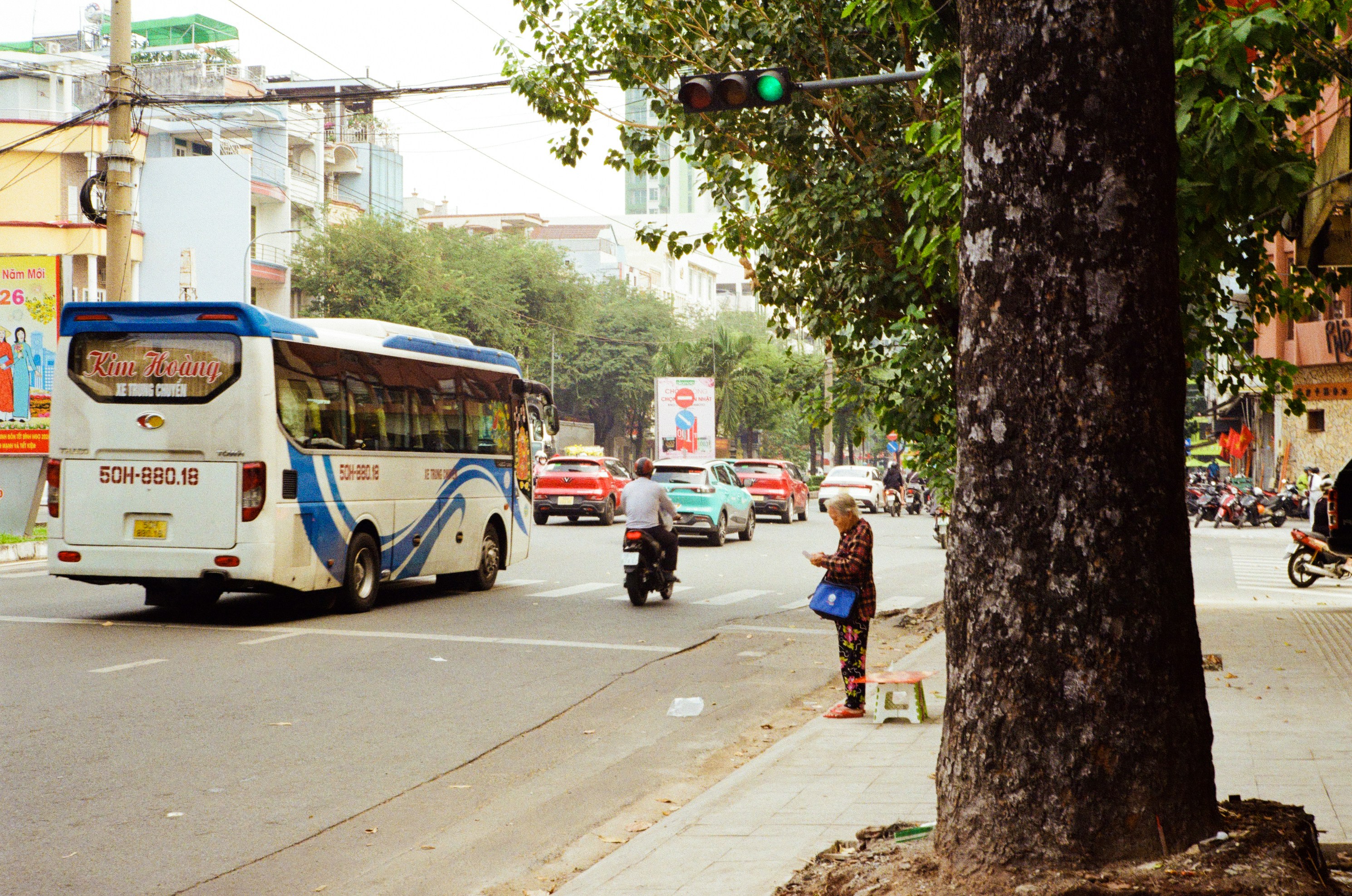 A bus drives down a busy street with traffic.