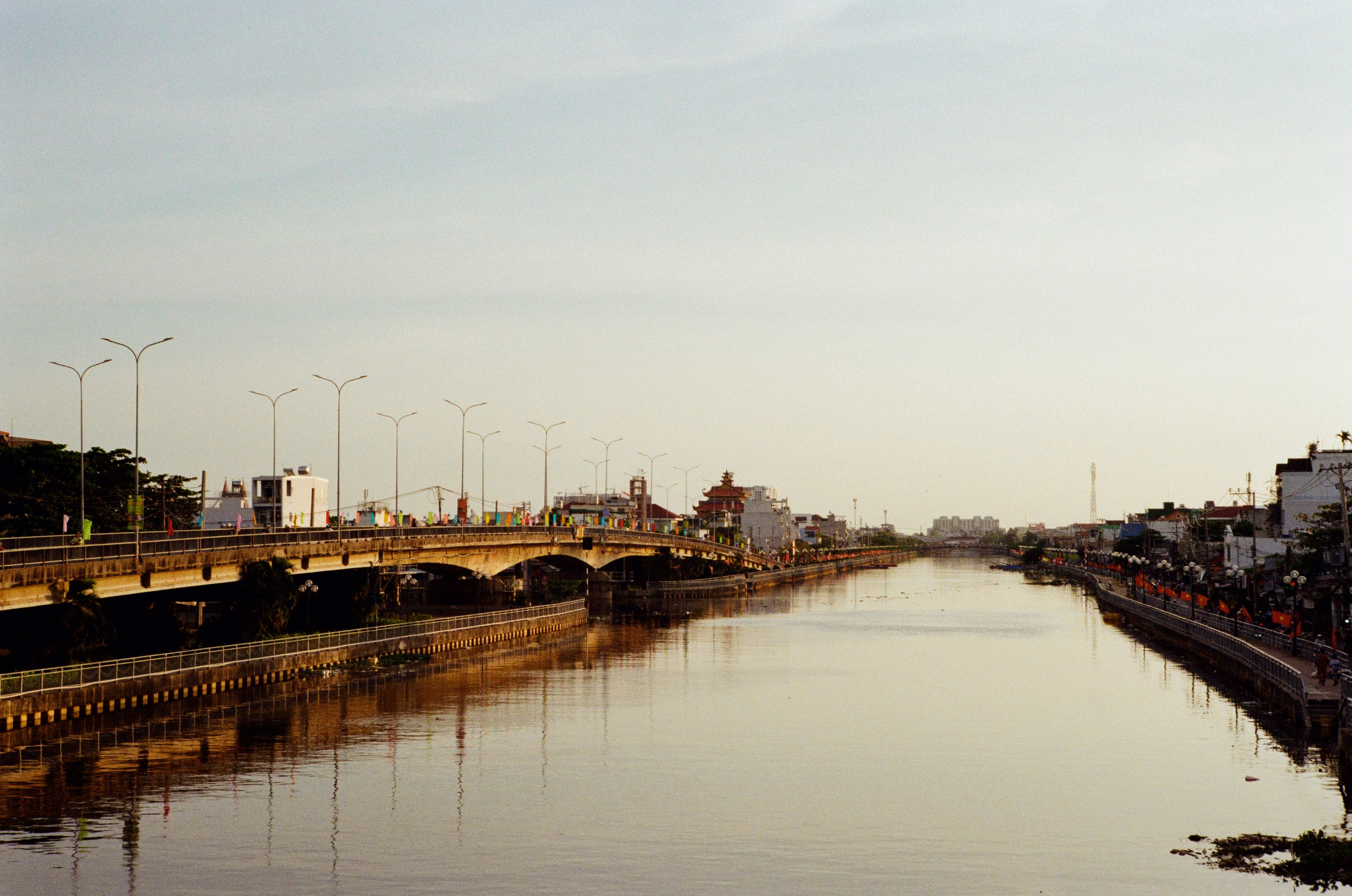 A wide canal with bridges and buildings on both sides.