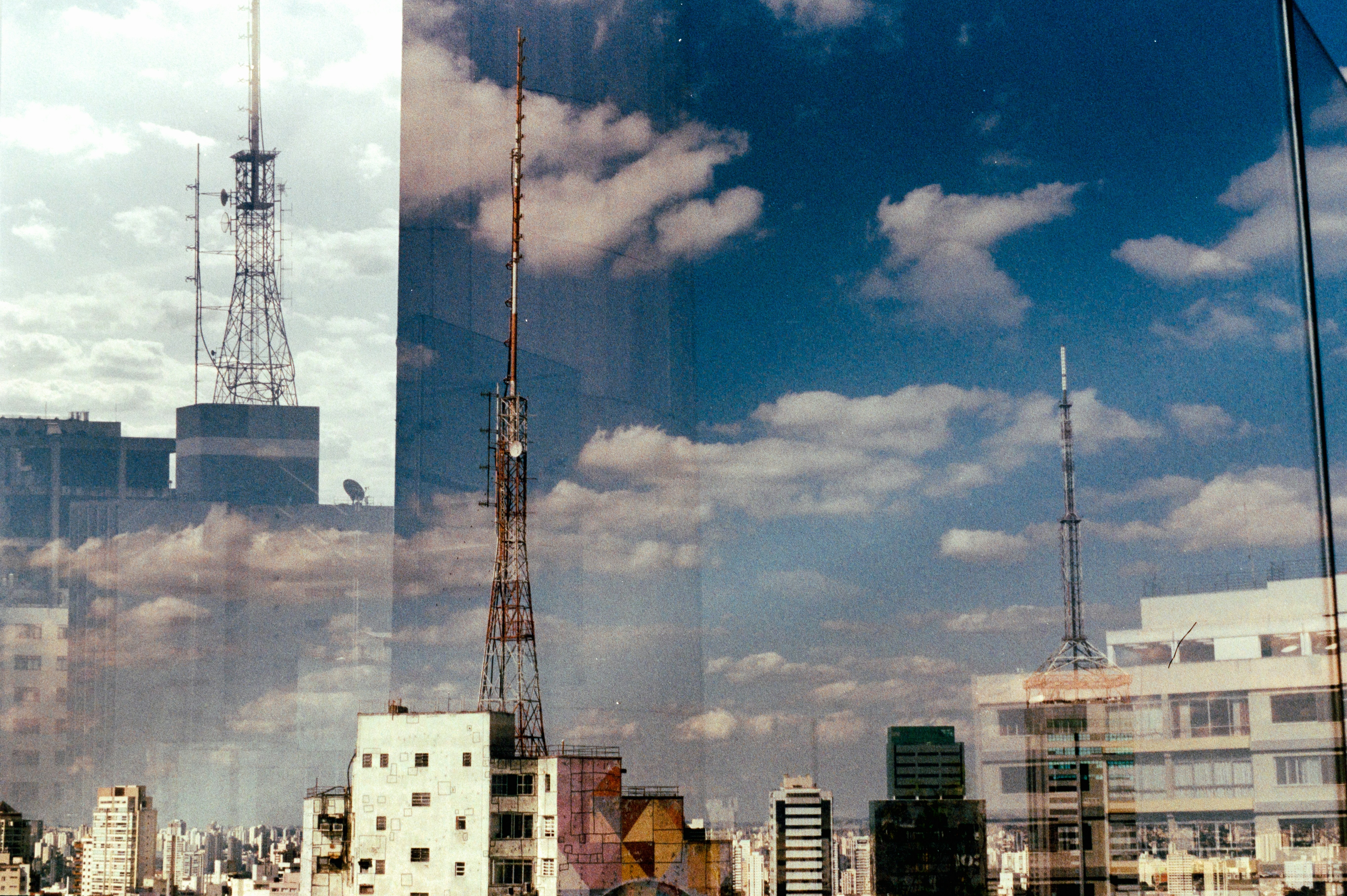 City skyline with radio towers and clouds
