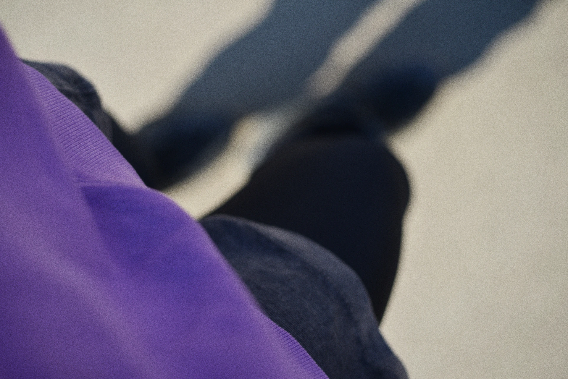 Person wearing purple and black with shadows