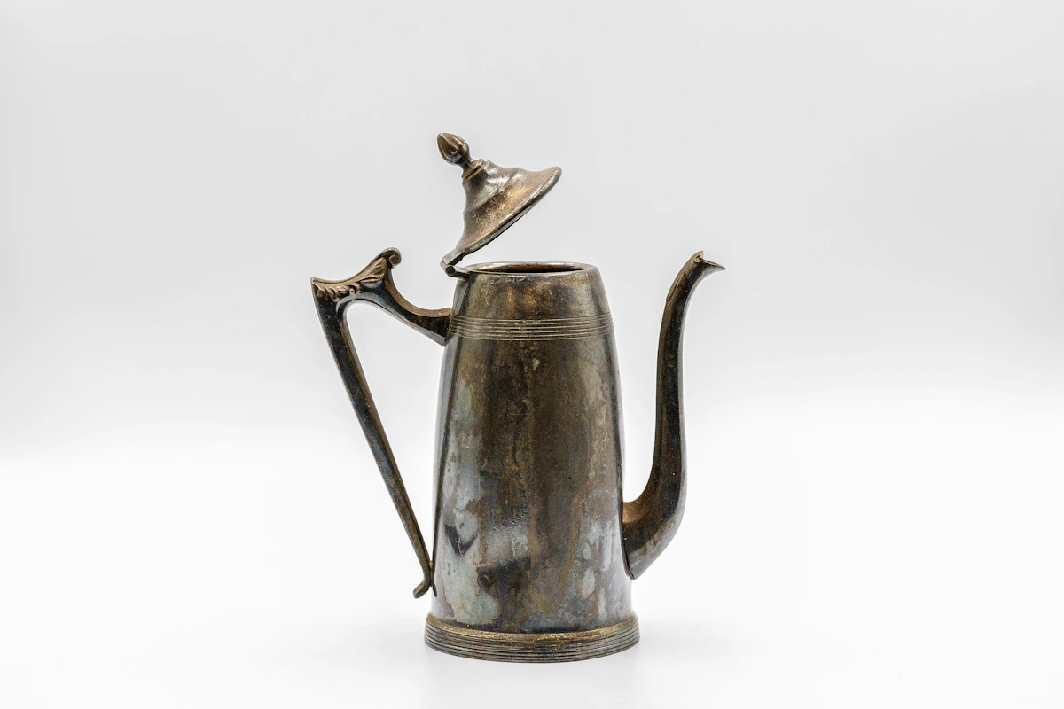 Antique silver coffee pot with elegant lighter-gauge styling