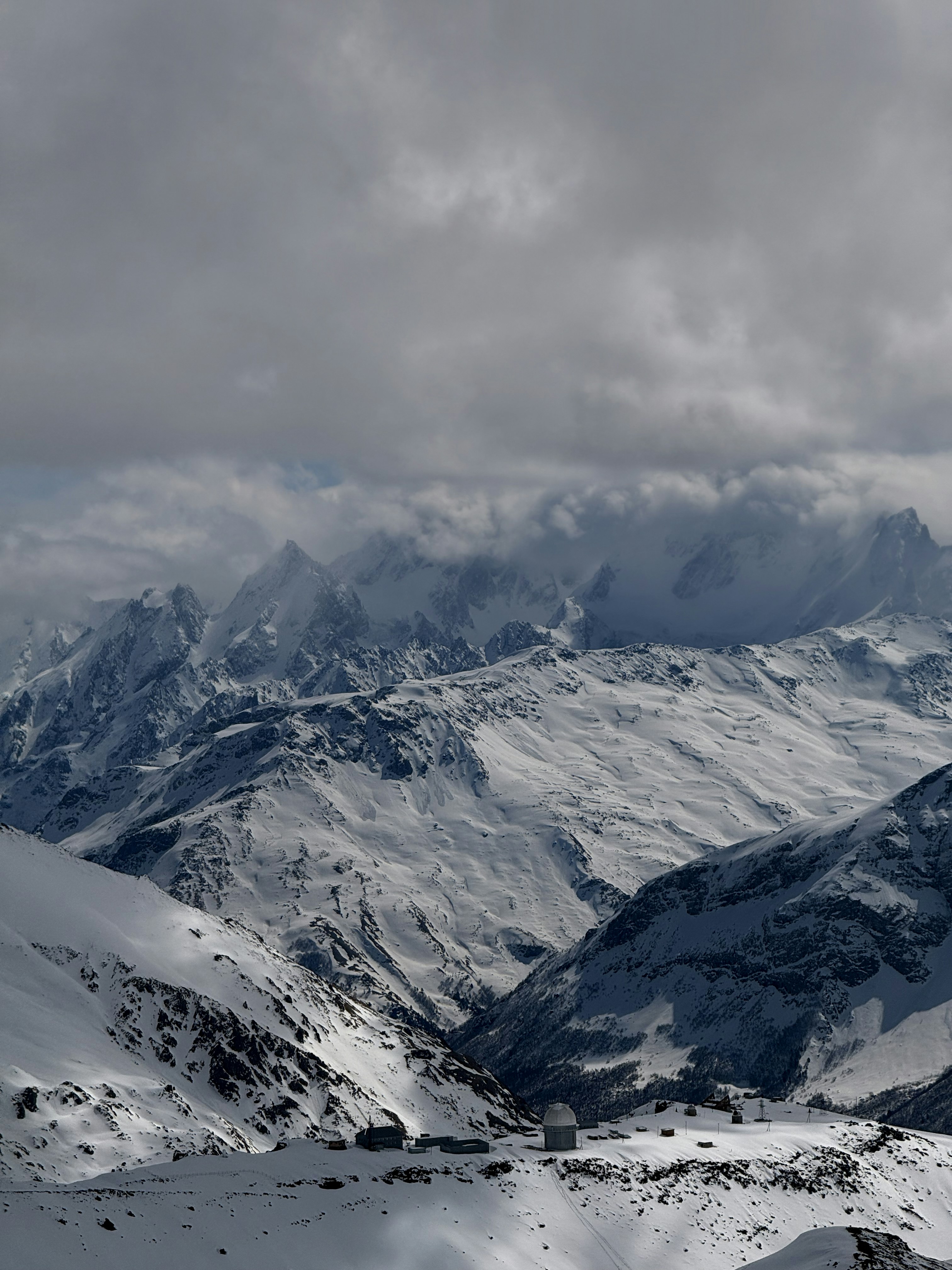 Snow-covered mountains under a cloudy sky