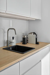 Modern kitchen counter with sink and coffee machine