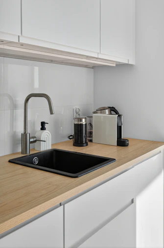 Modern kitchen counter with sink and coffee machine