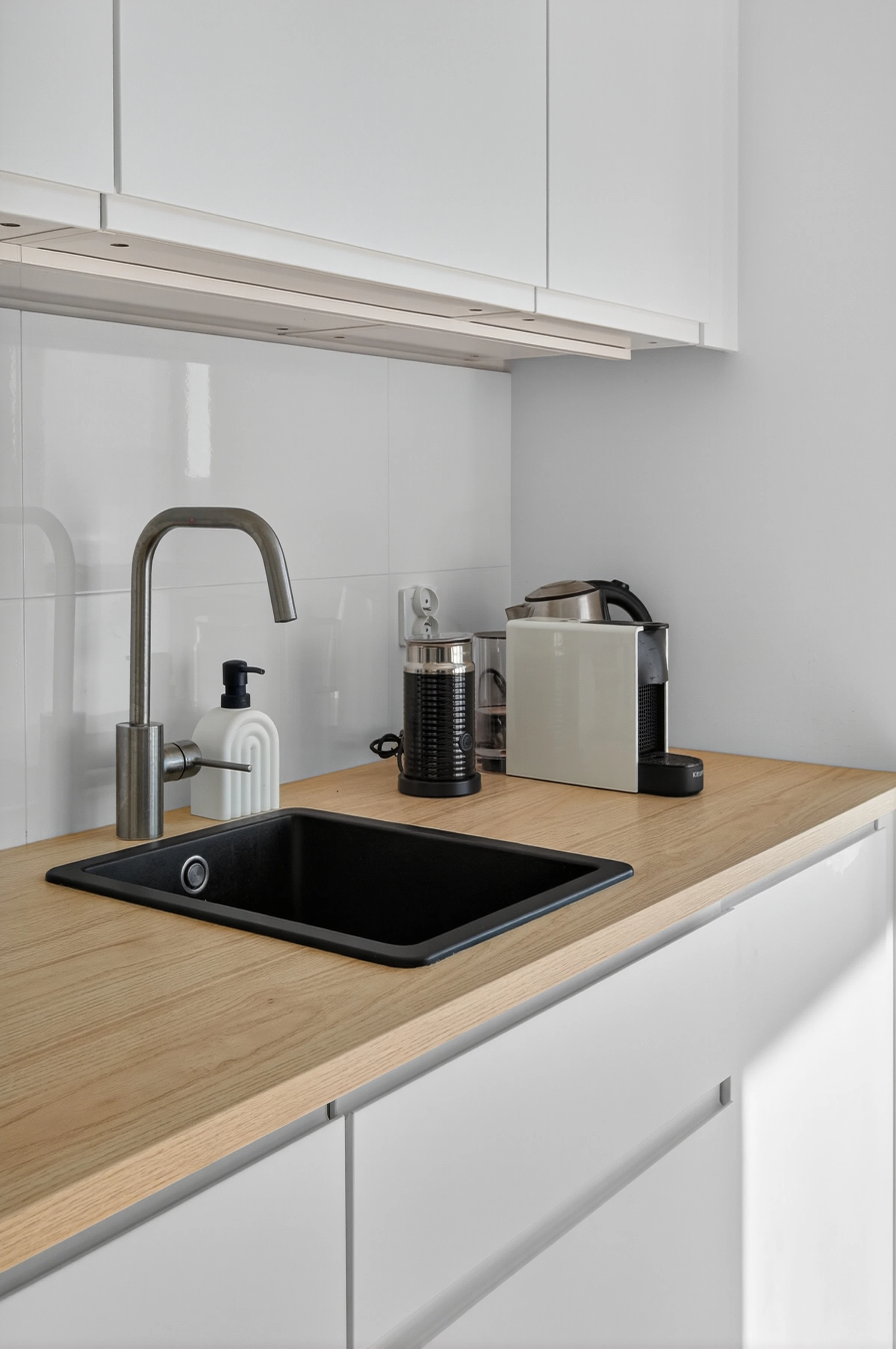 Modern kitchen counter with a coffee machine and small kitchen appliances