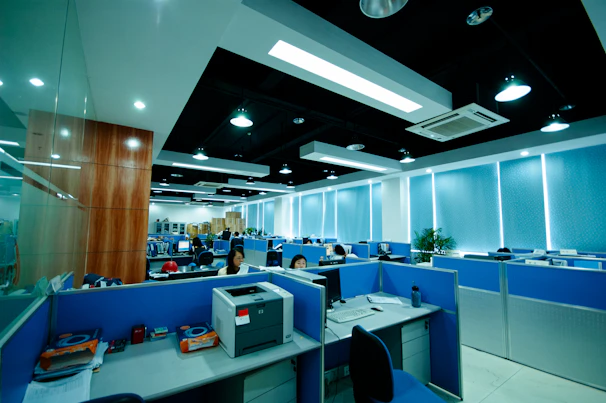 Modern office interior with cubicles and workstations.