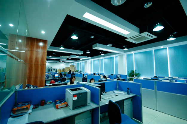 Modern office interior with cubicles and workstations.