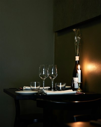 Table set for two with wine and candles