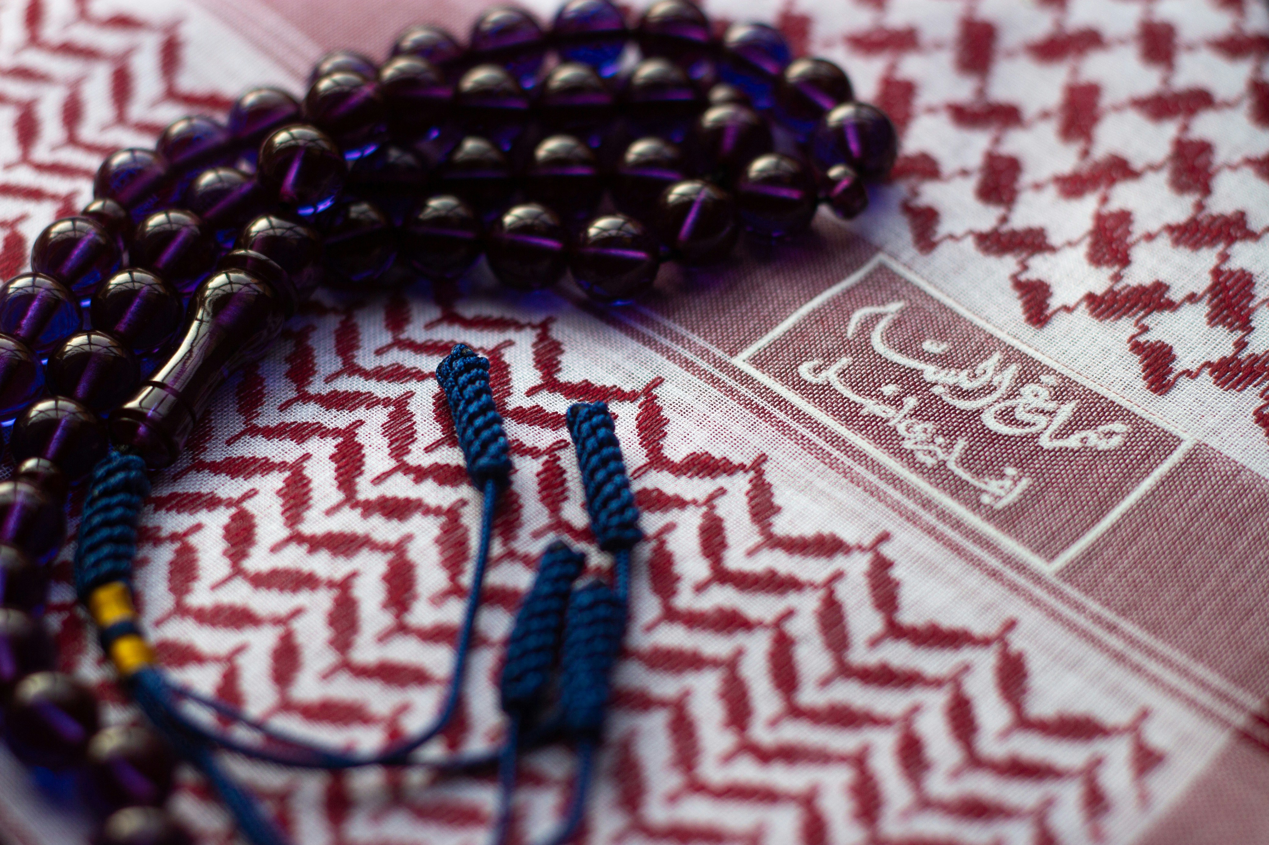 purple prayer beads on red cloth