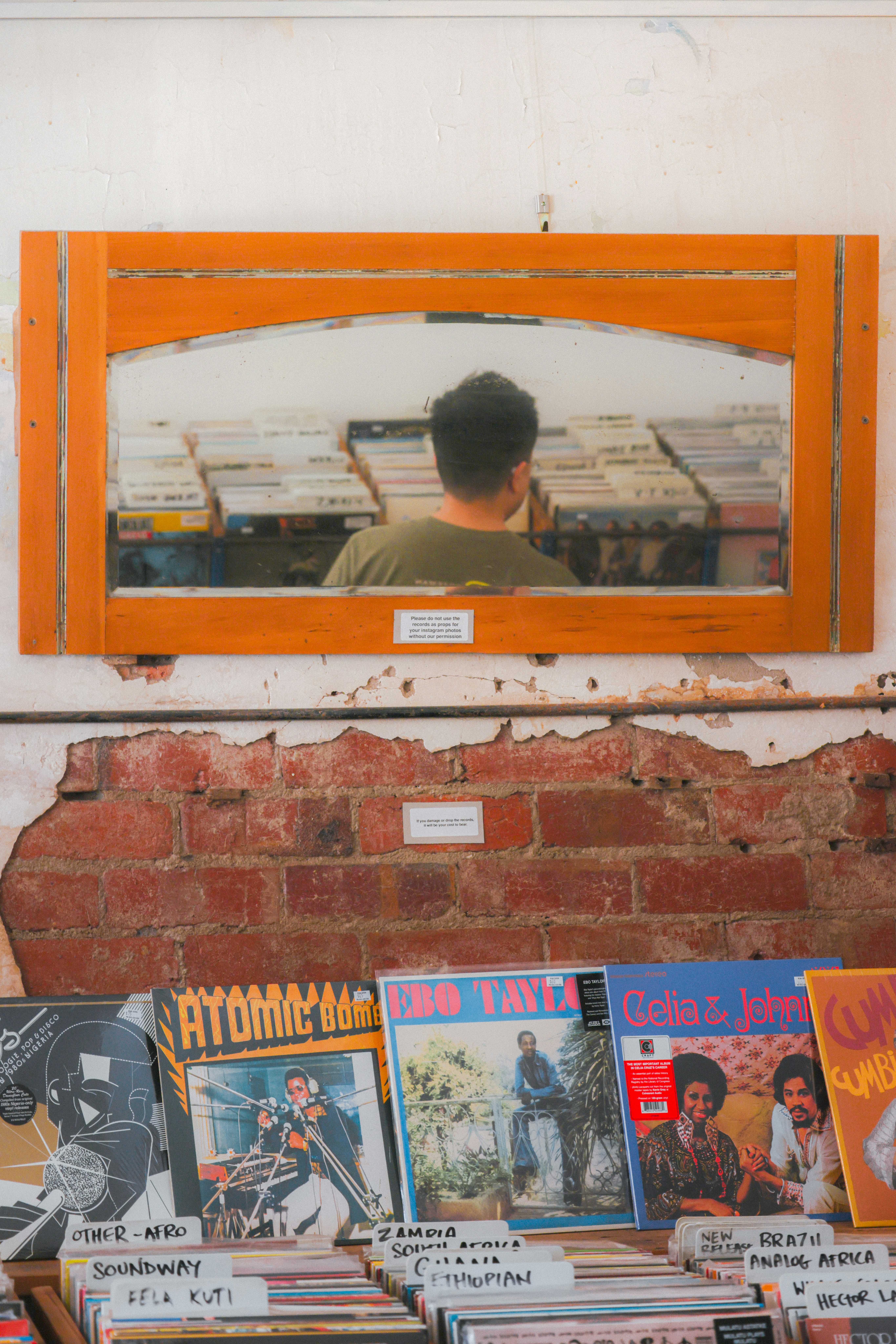 Rows of curated vinyl records and vintage posters create a nostalgic sanctuary for music lovers in this local record shop.