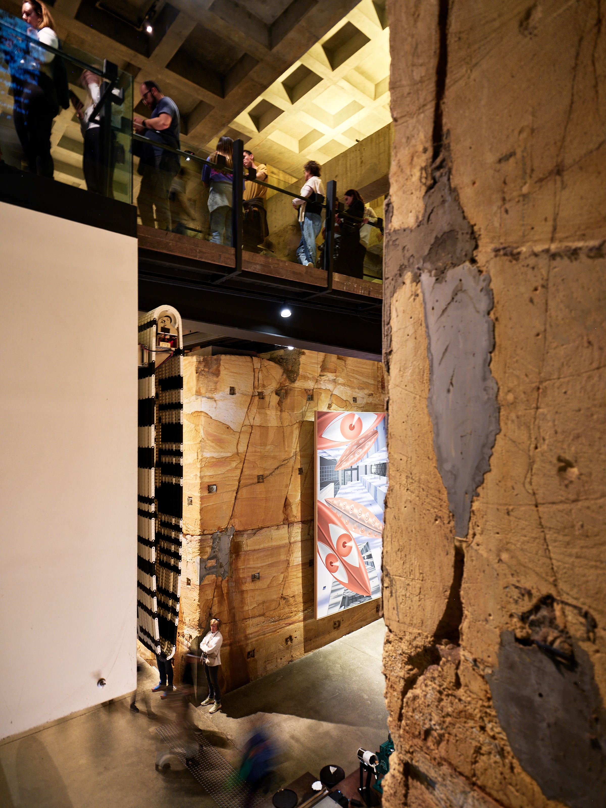Visitors observing artworks in a modern museum interior
