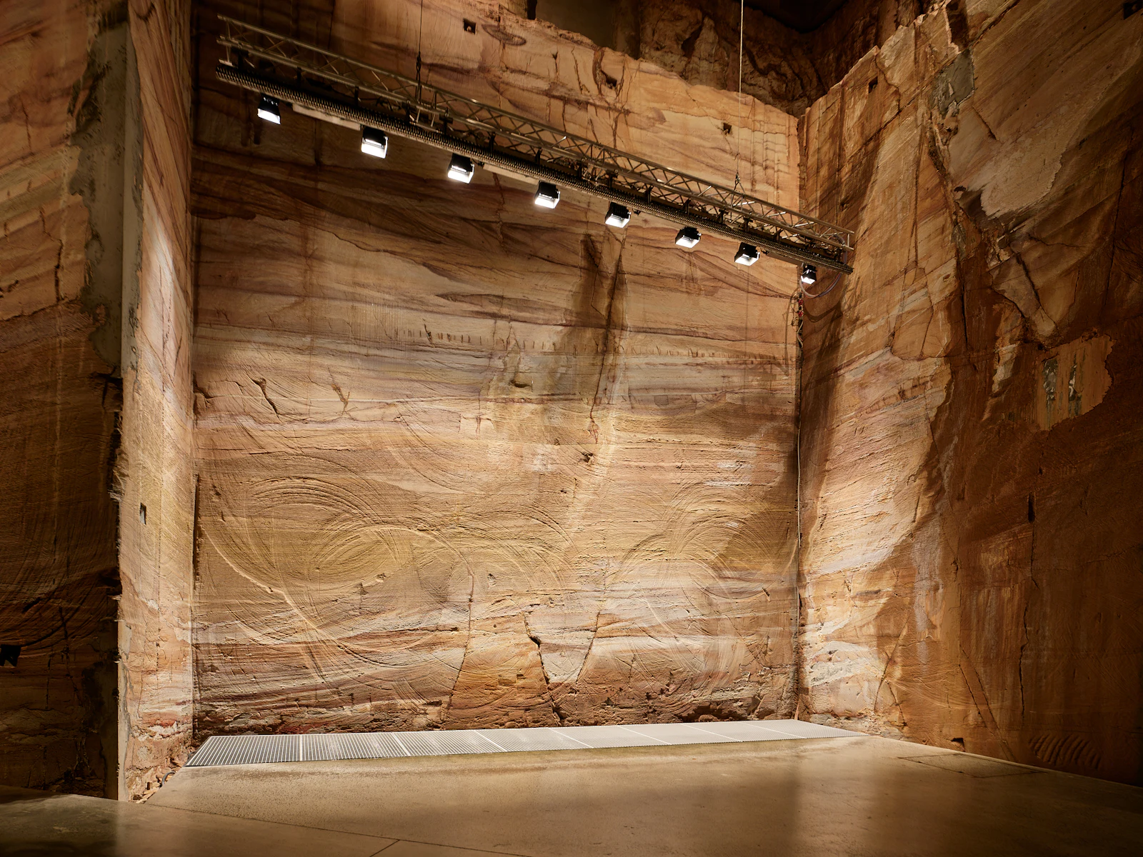 The cut sandstone walls inside a working quarry.