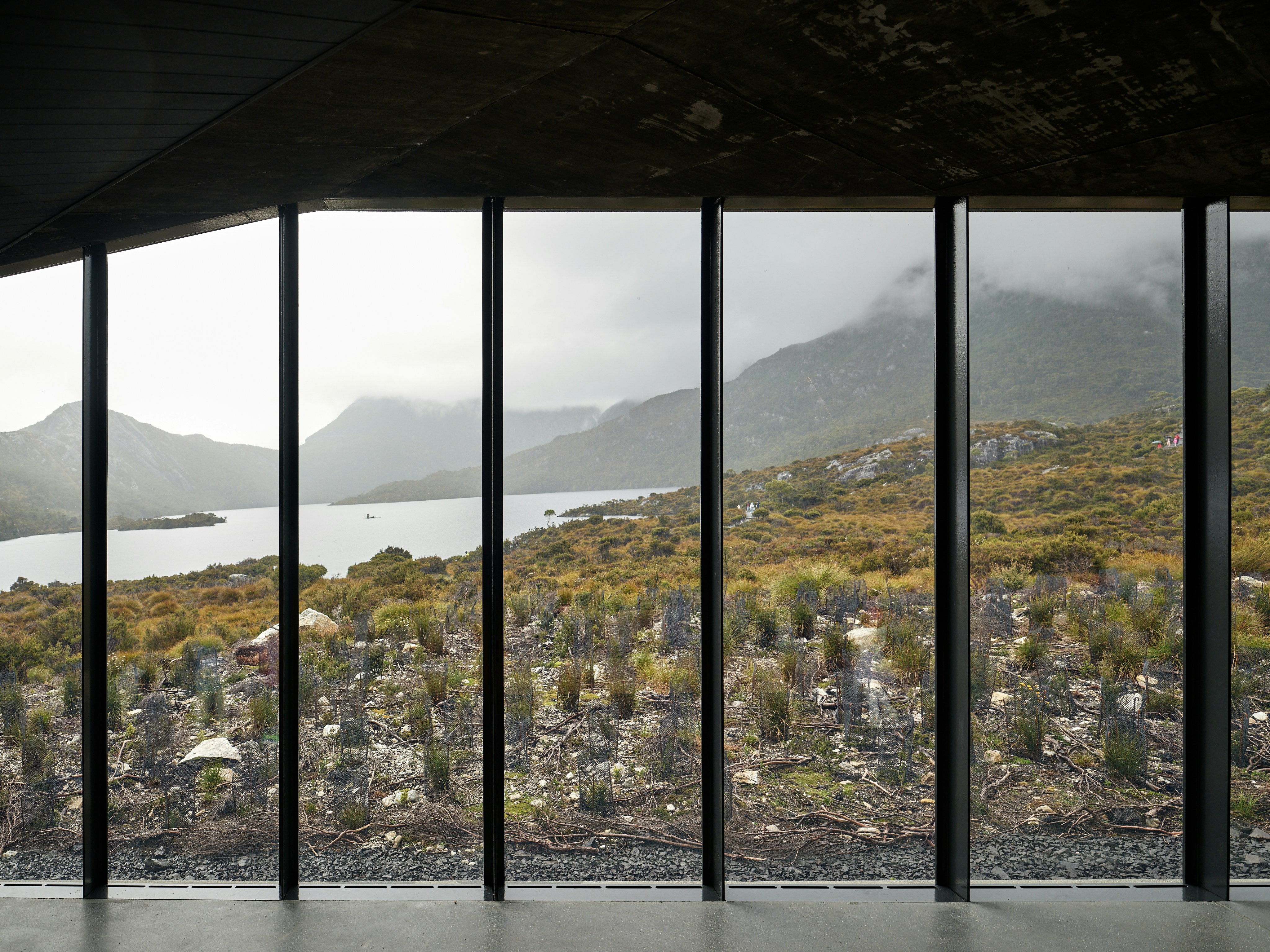 View of mountains and water through large windows