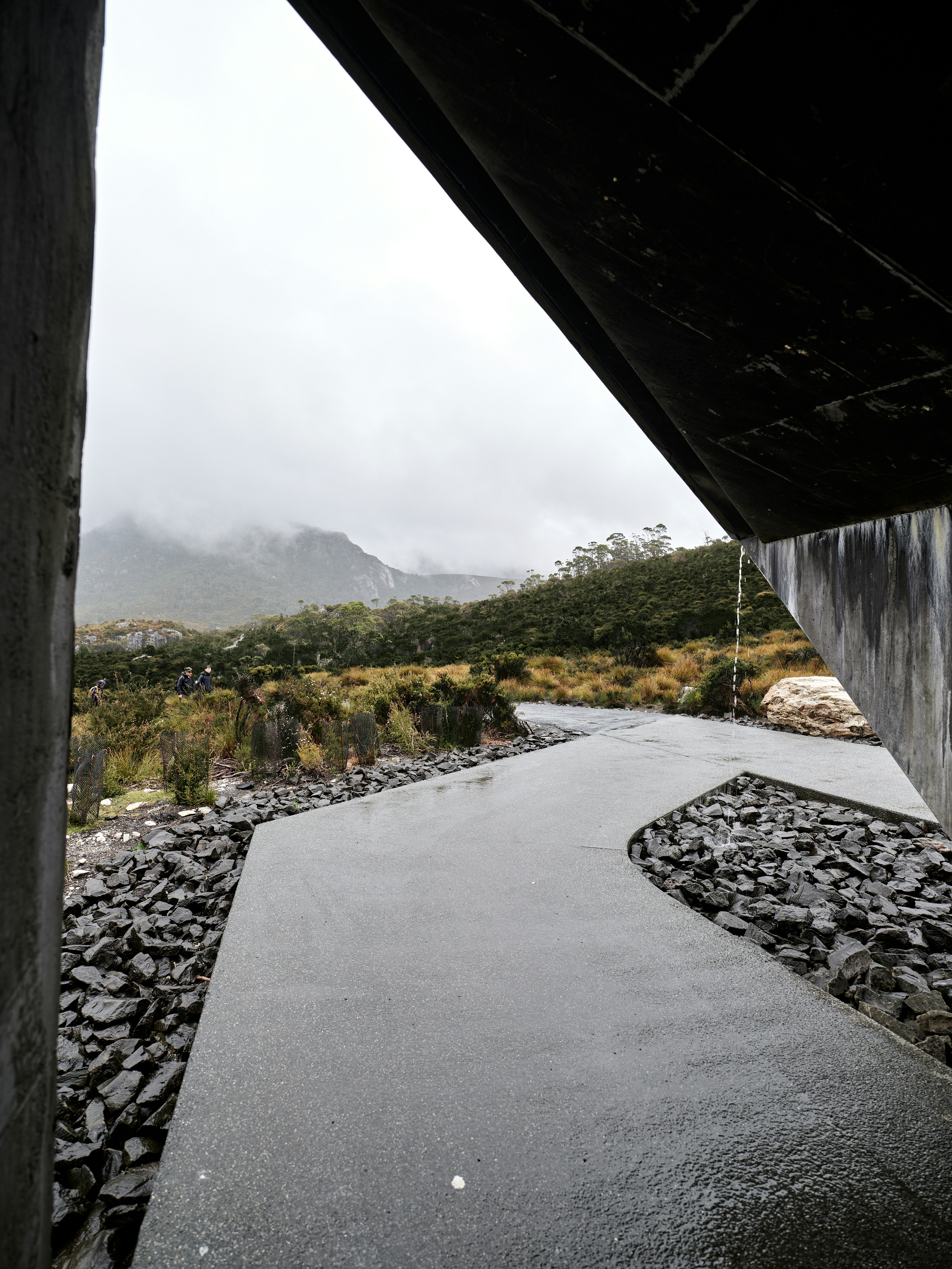 Modern building entrance overlooks misty mountain landscape.