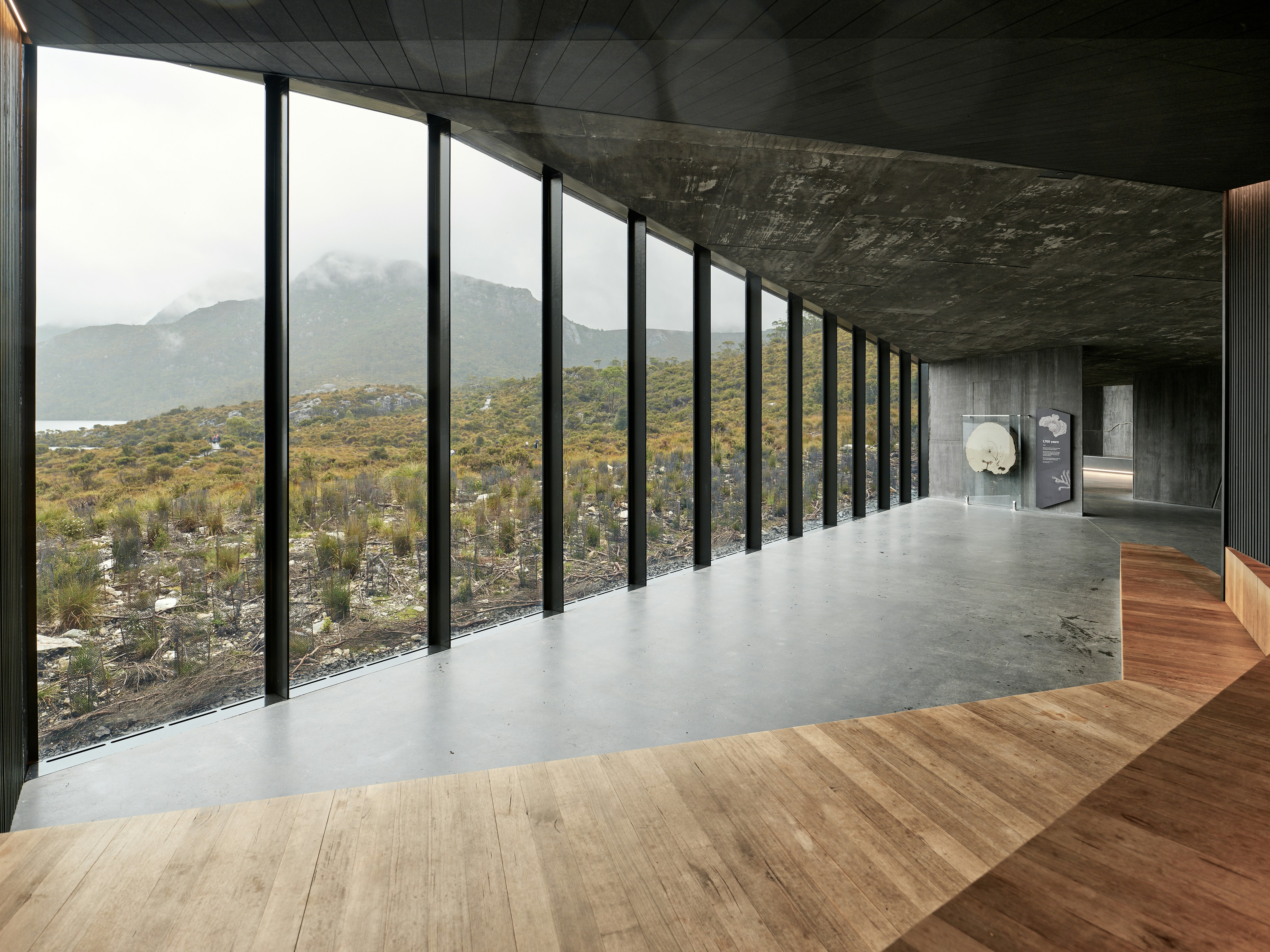 Modern building with large windows overlooking autumn landscape