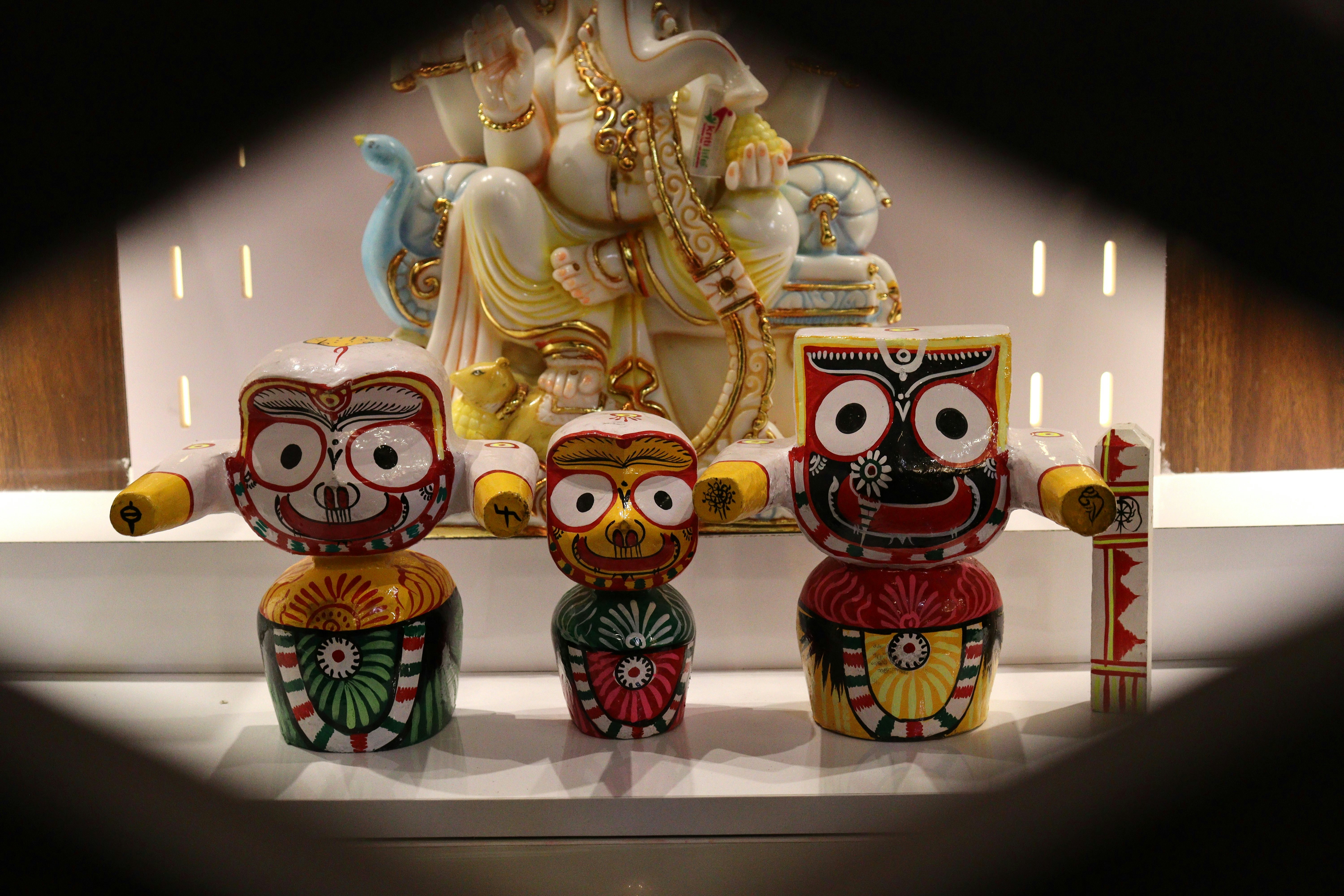 Three colorful wooden statues of deities