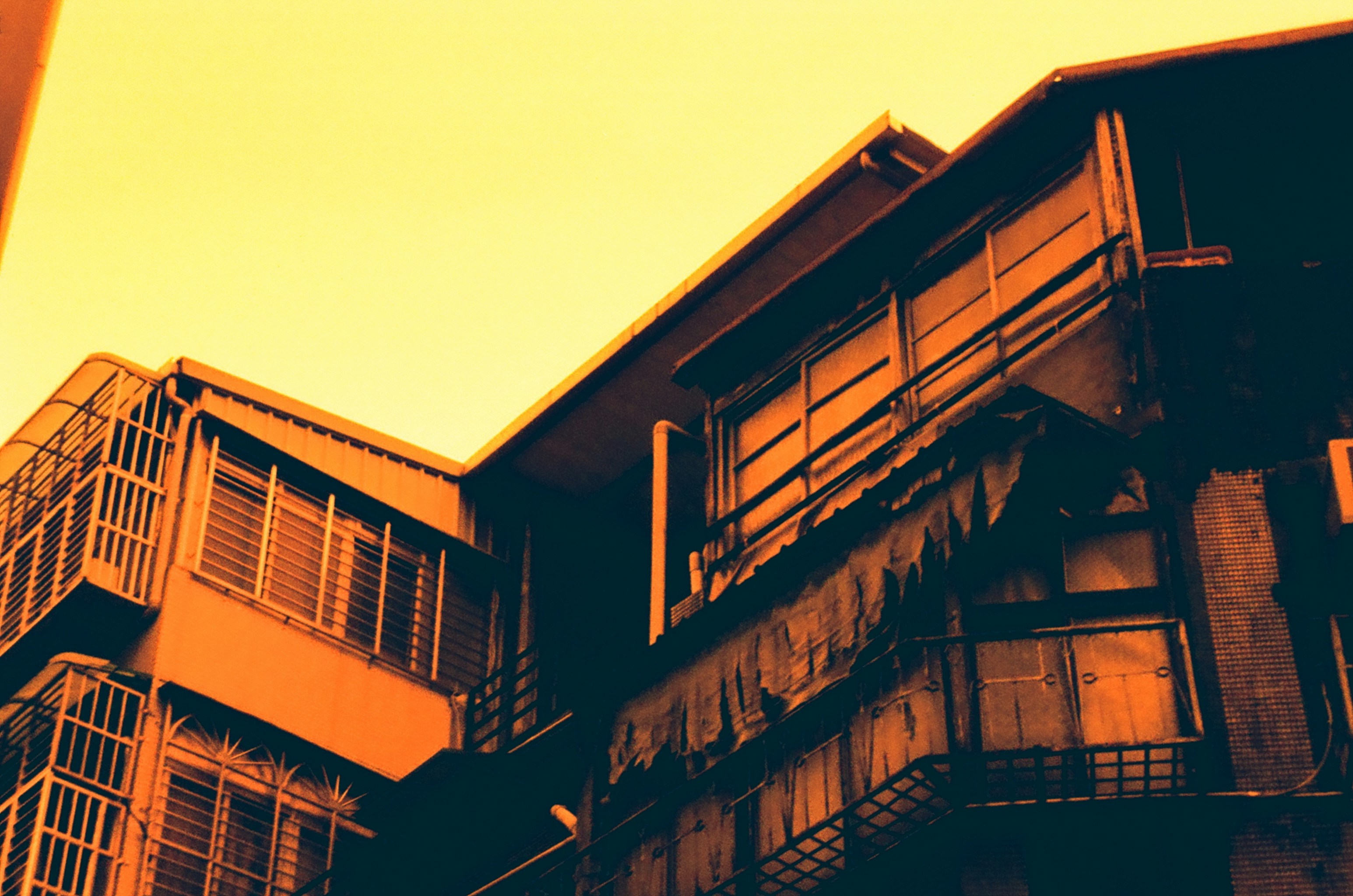 Apartment buildings with balconies under a bright sky