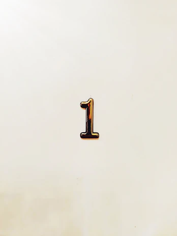 A single metallic number one on a light background