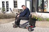 Man riding a mobility scooter outdoors