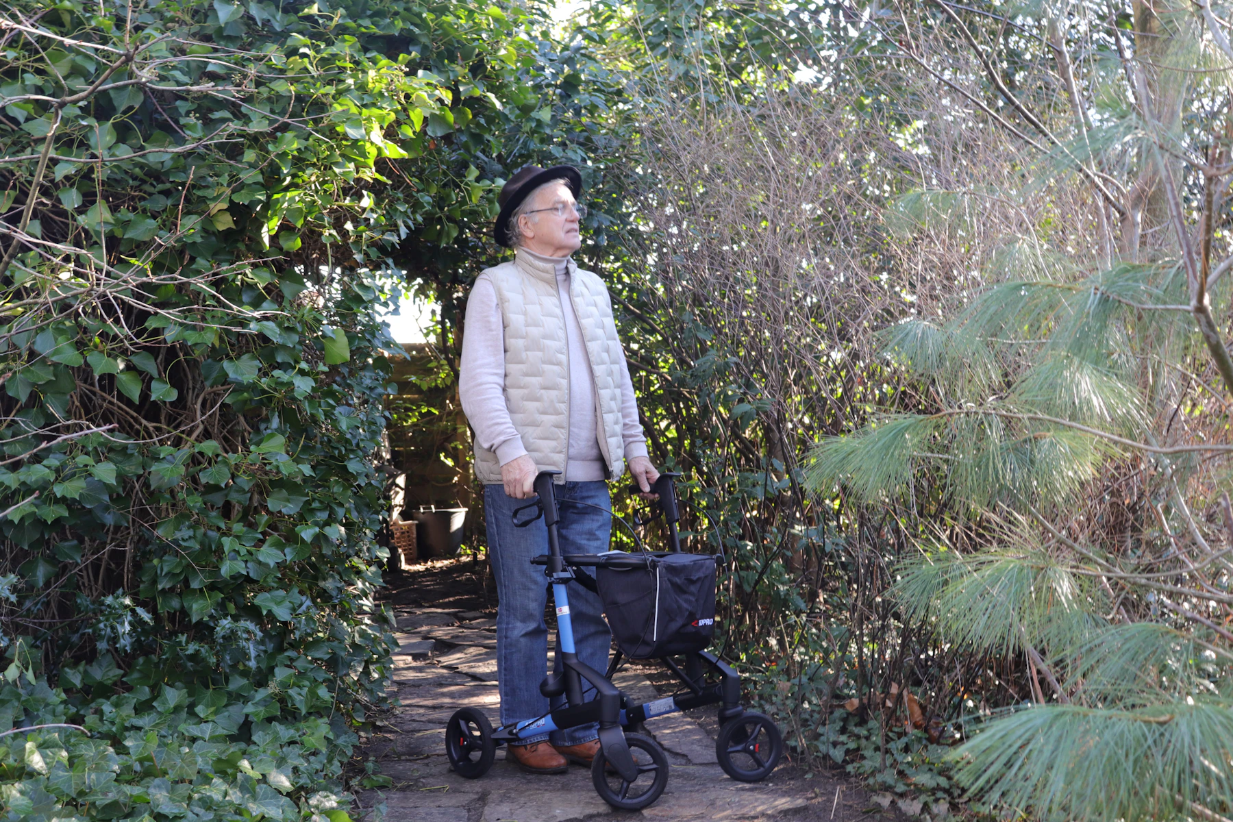 Older adult walking outdoors with a mobility aid