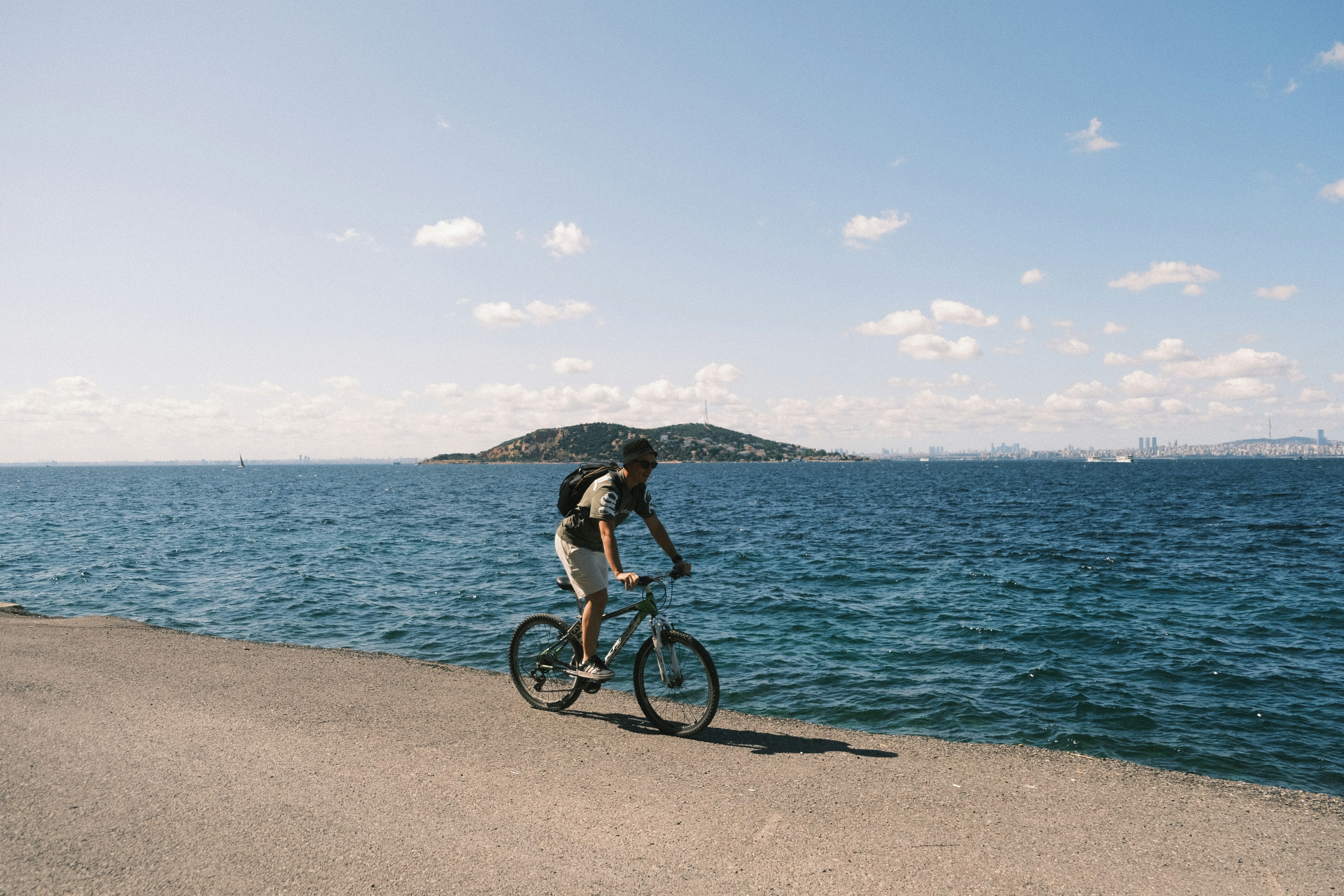 Man riding a bicycle along the waterfront