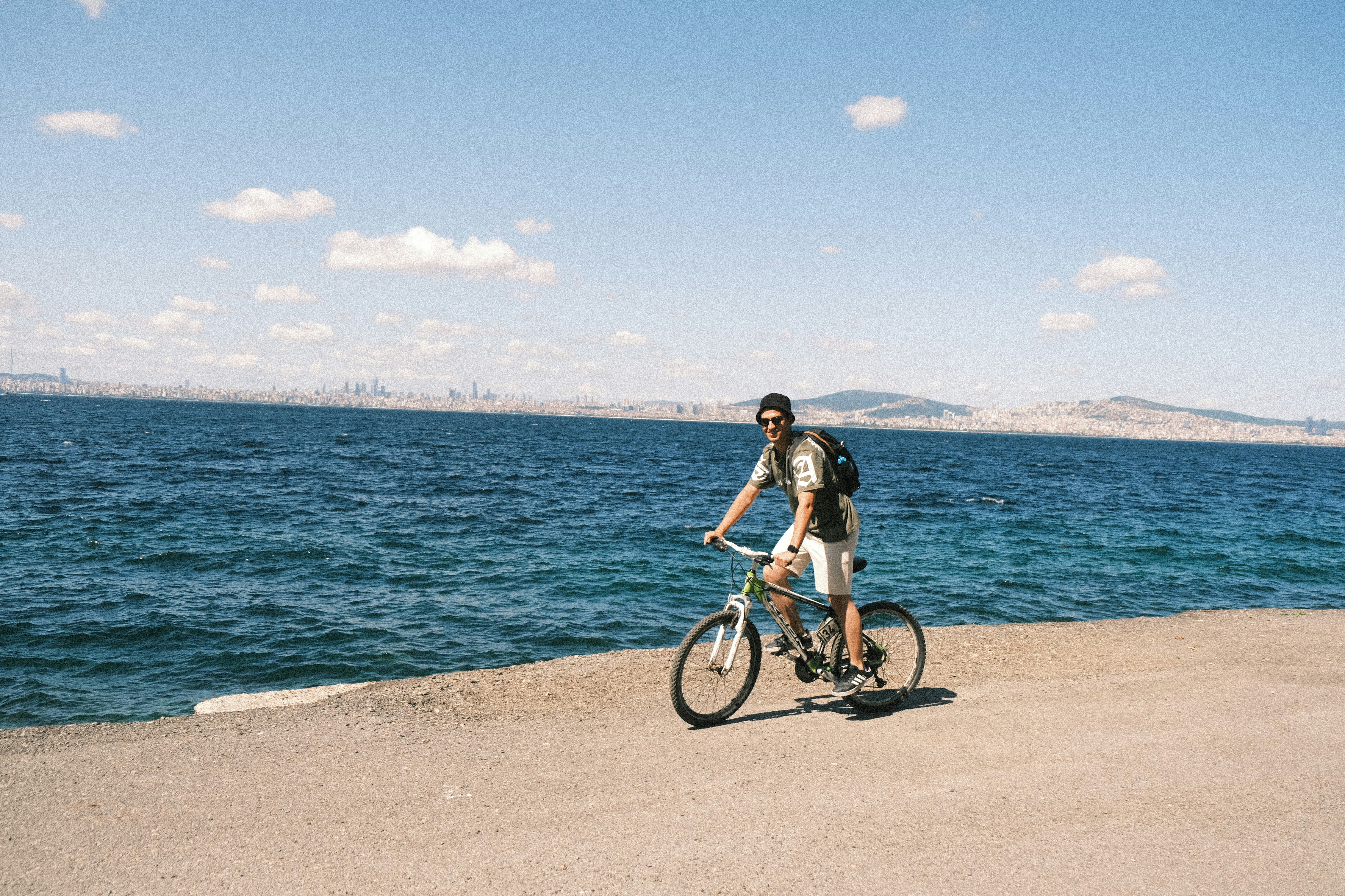 Man riding a bicycle near the ocean