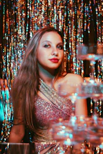 Young woman in sparkling dress at a party