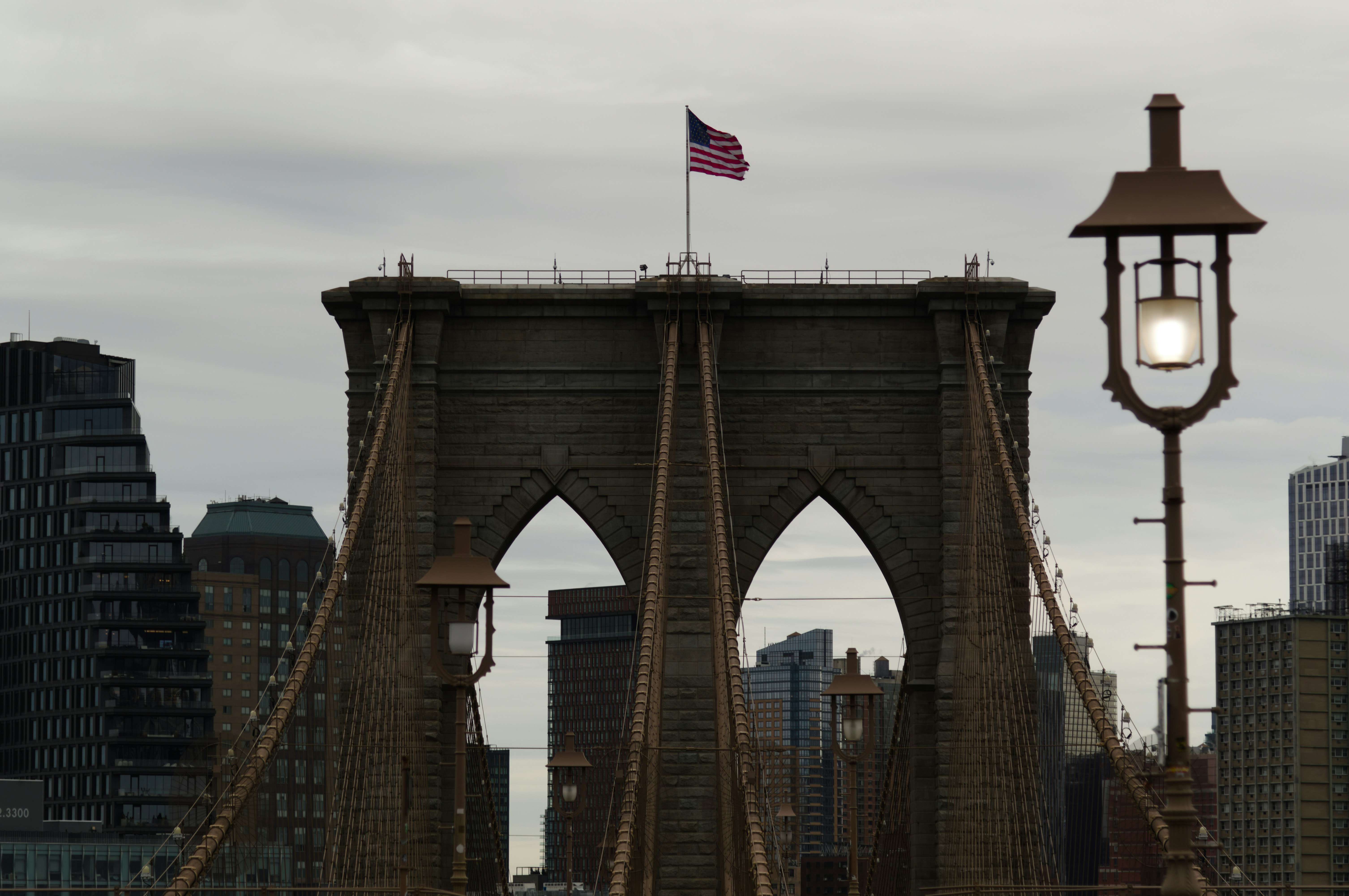 Brooklyn bridge with american flag and lamppost