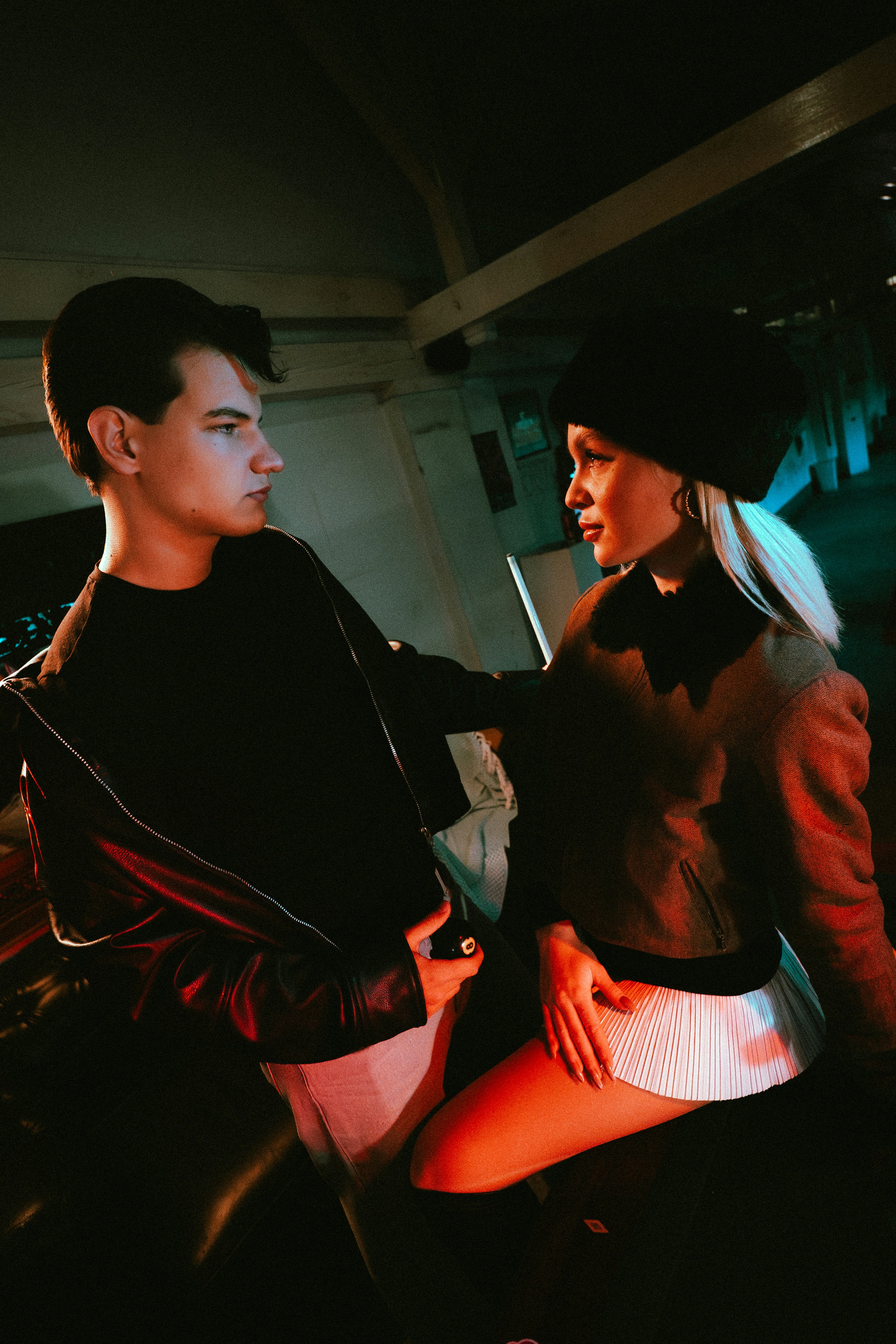 Young couple looking at each other in dim lighting