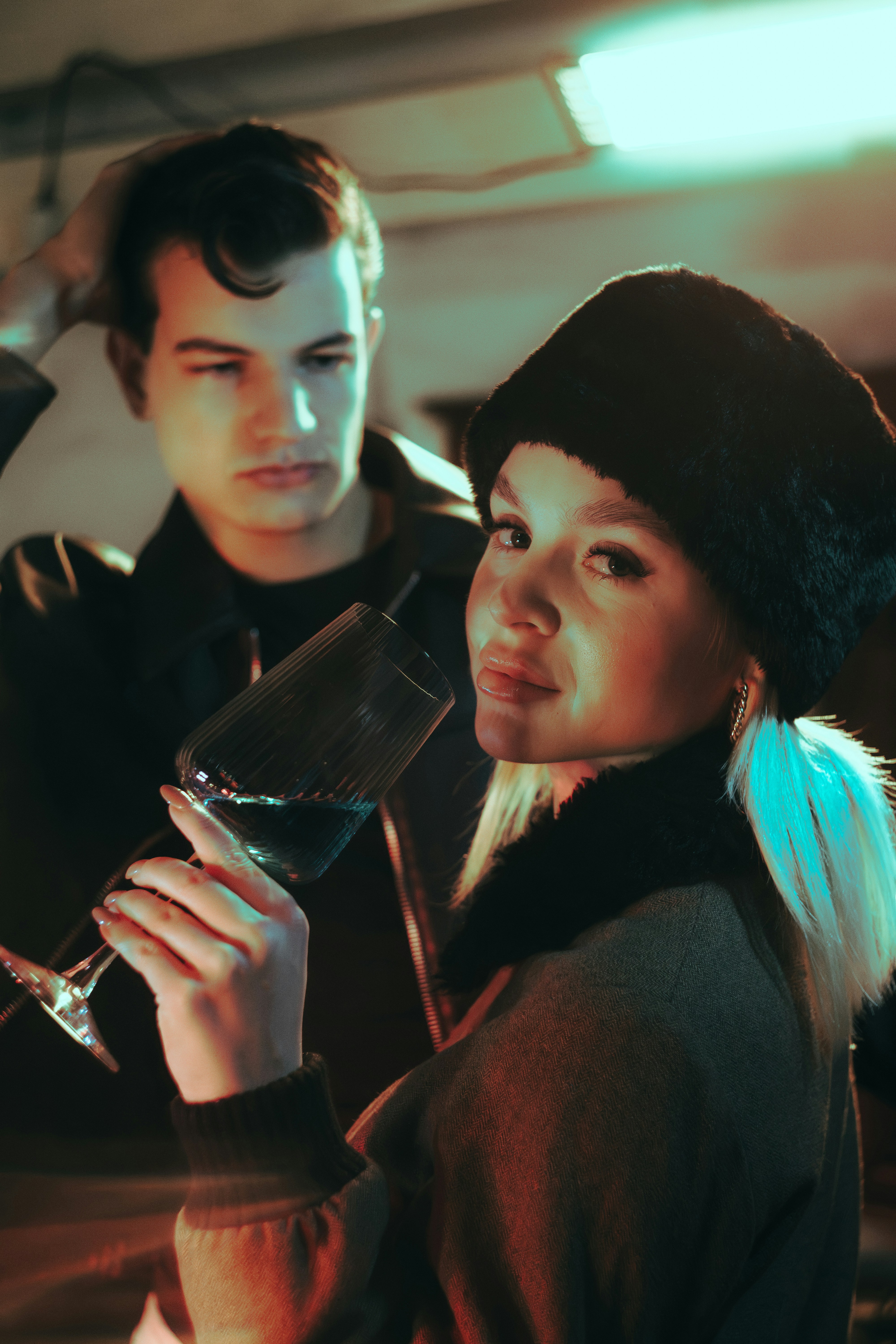 Couple holding a glass of blue liquid