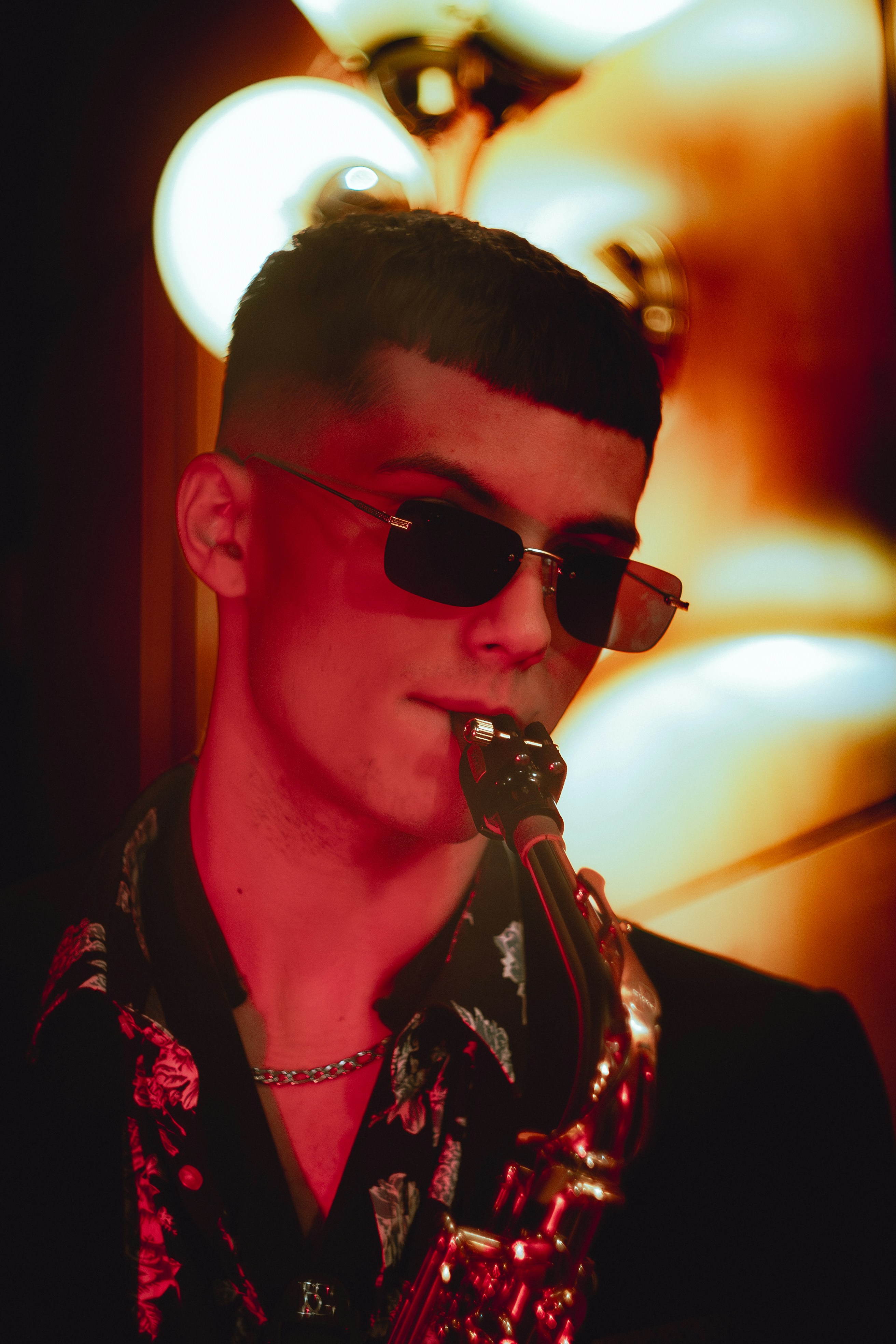 Man playing saxophone with sunglasses