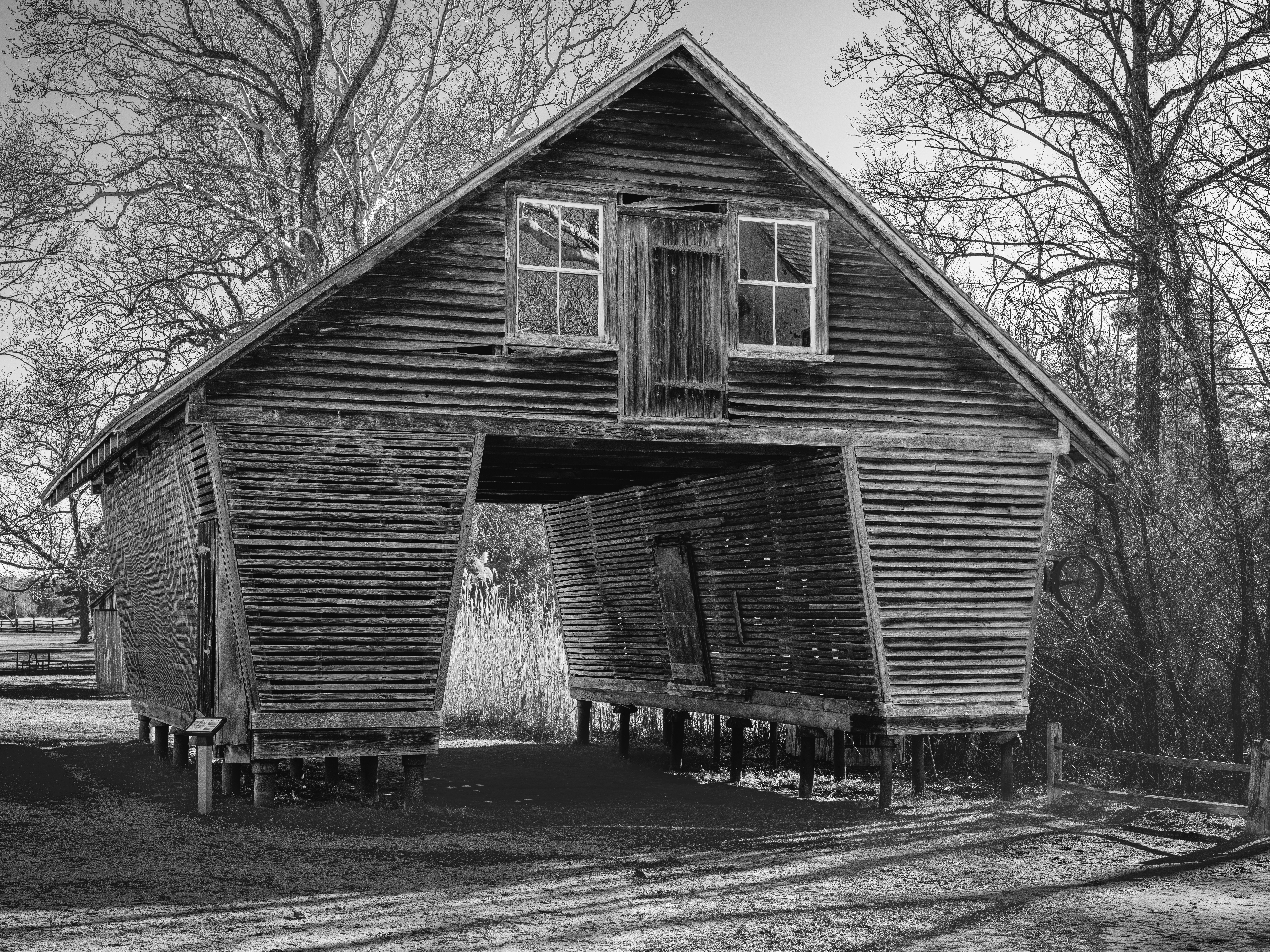 An old wooden barn with an open entryway.