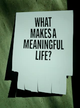 A paper with "what makes a meaningful life?" text.