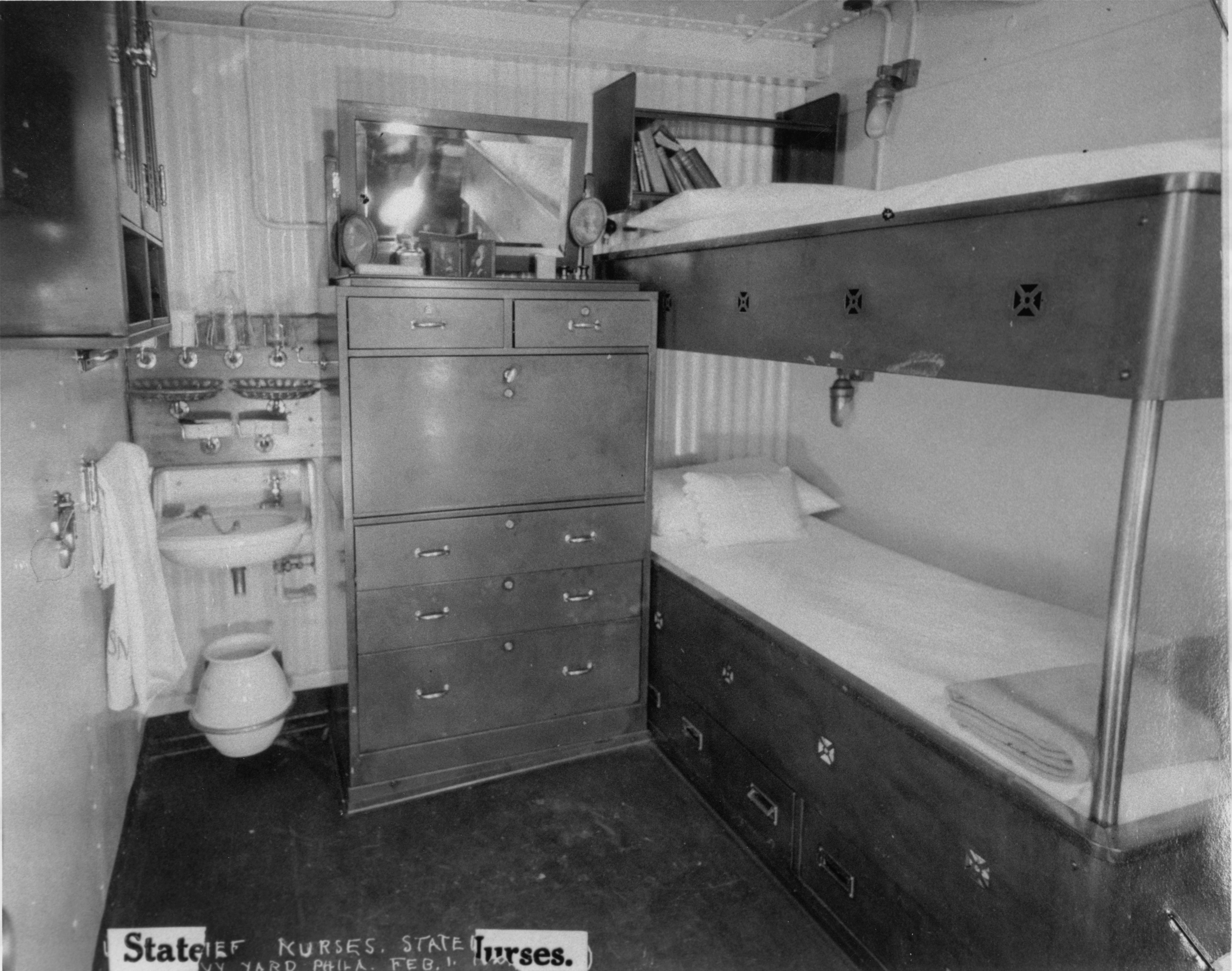 Bunk beds, dresser, and sink in a small room.