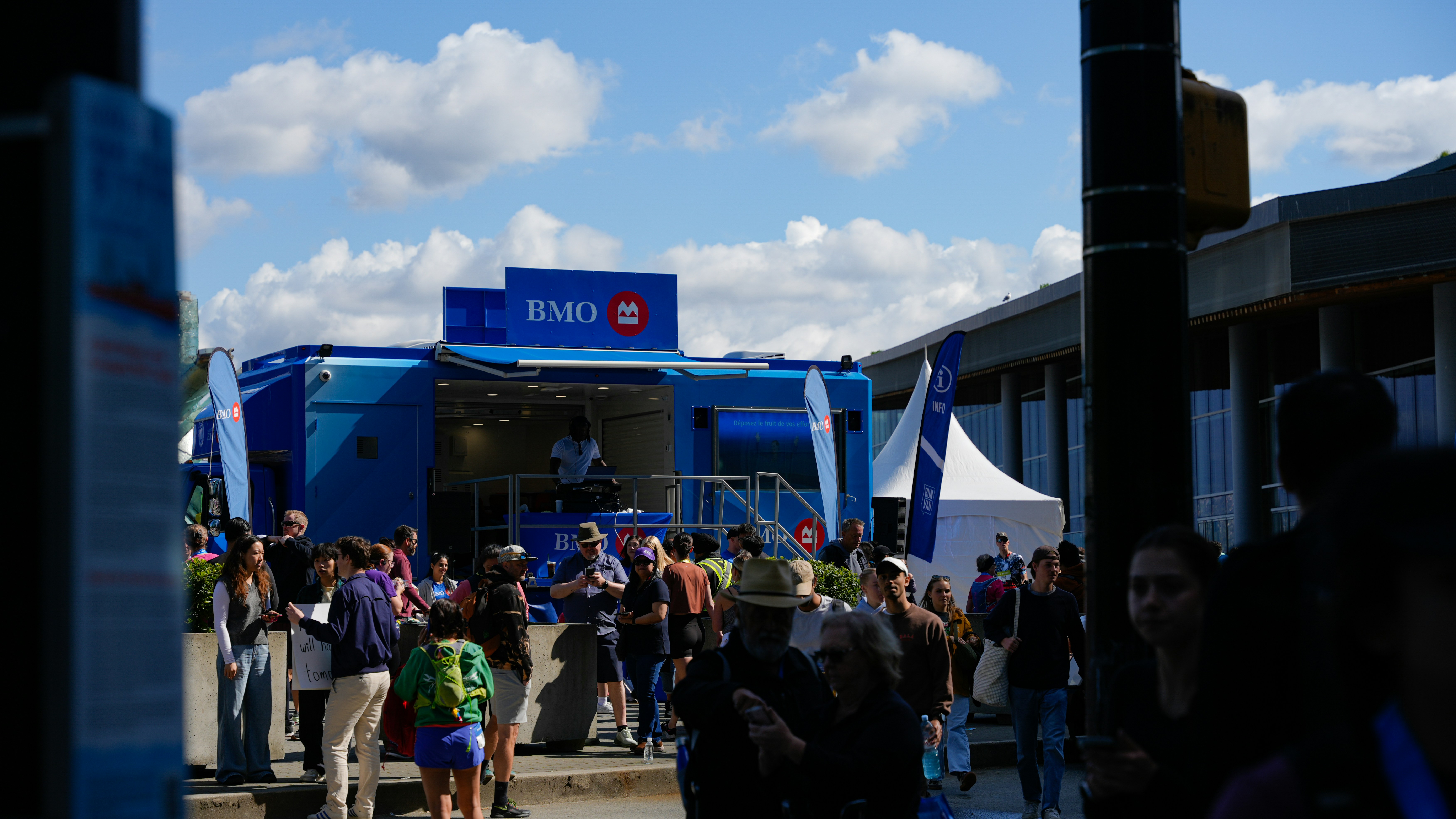 People gathered around a blue mobile unit with bmo logo.