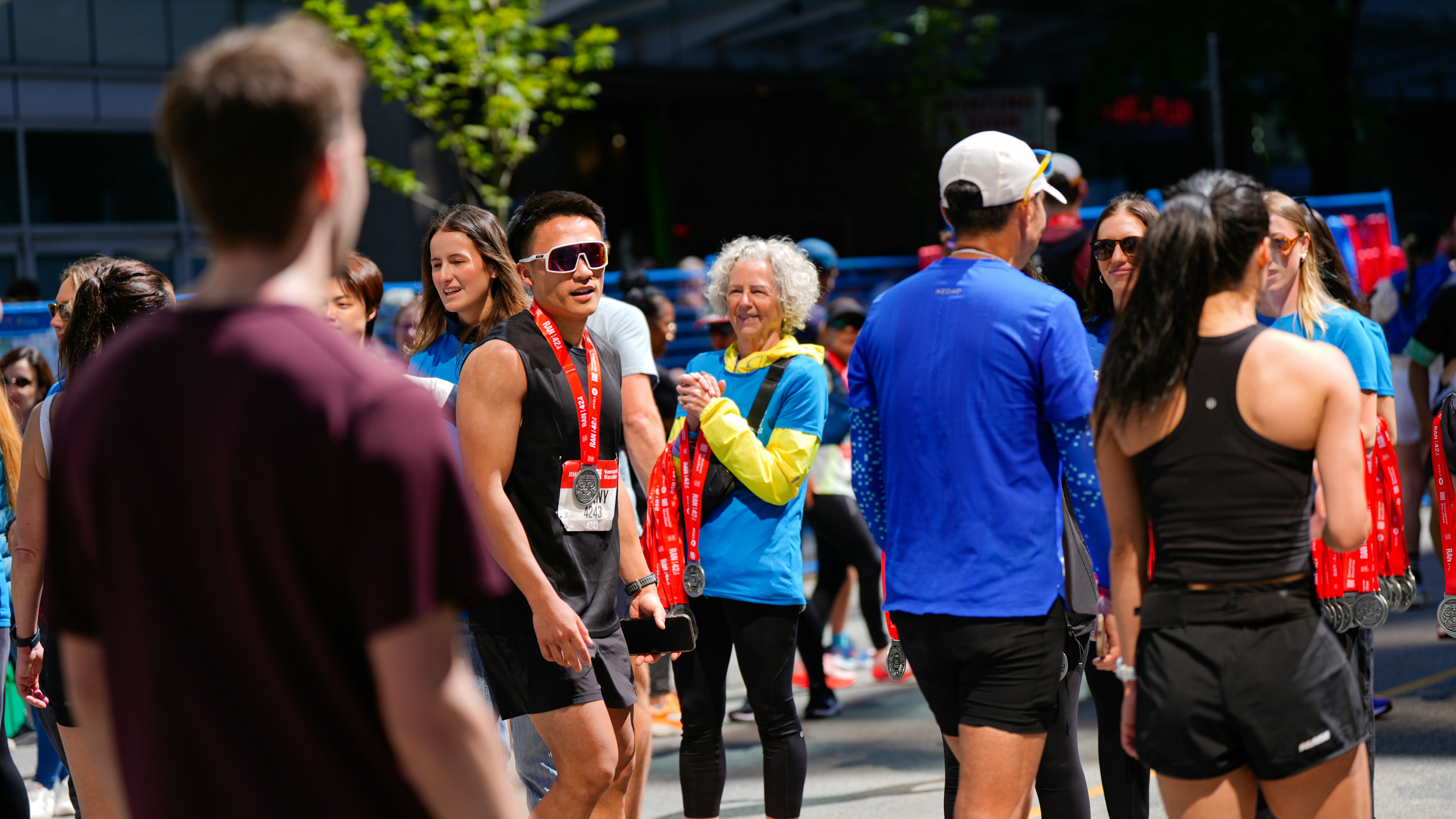 People in athletic wear gathered outdoors on a sunny day.