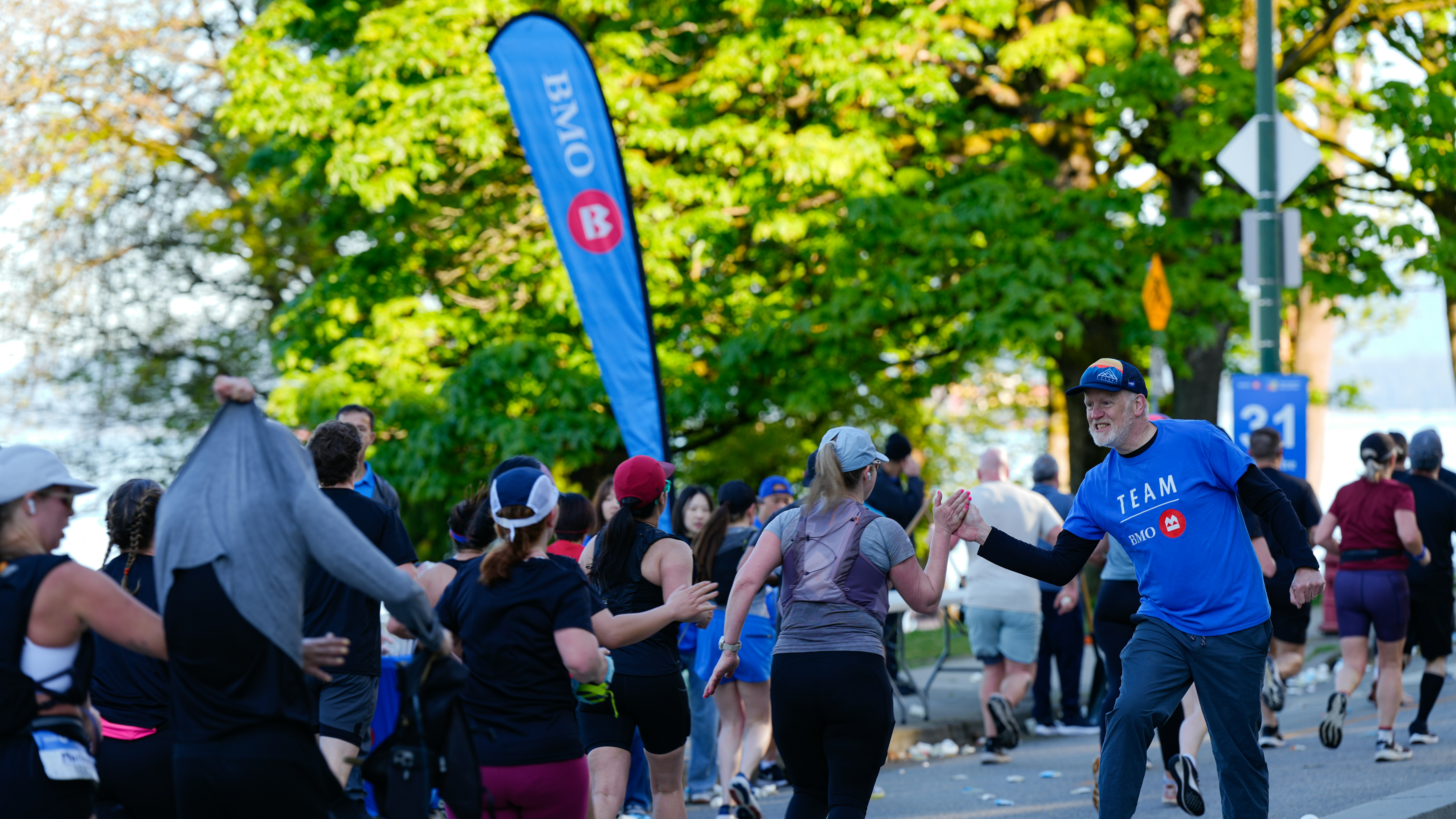 Runners in a race with a blue banner