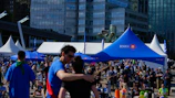 People gathered at an outdoor event with tents and tents