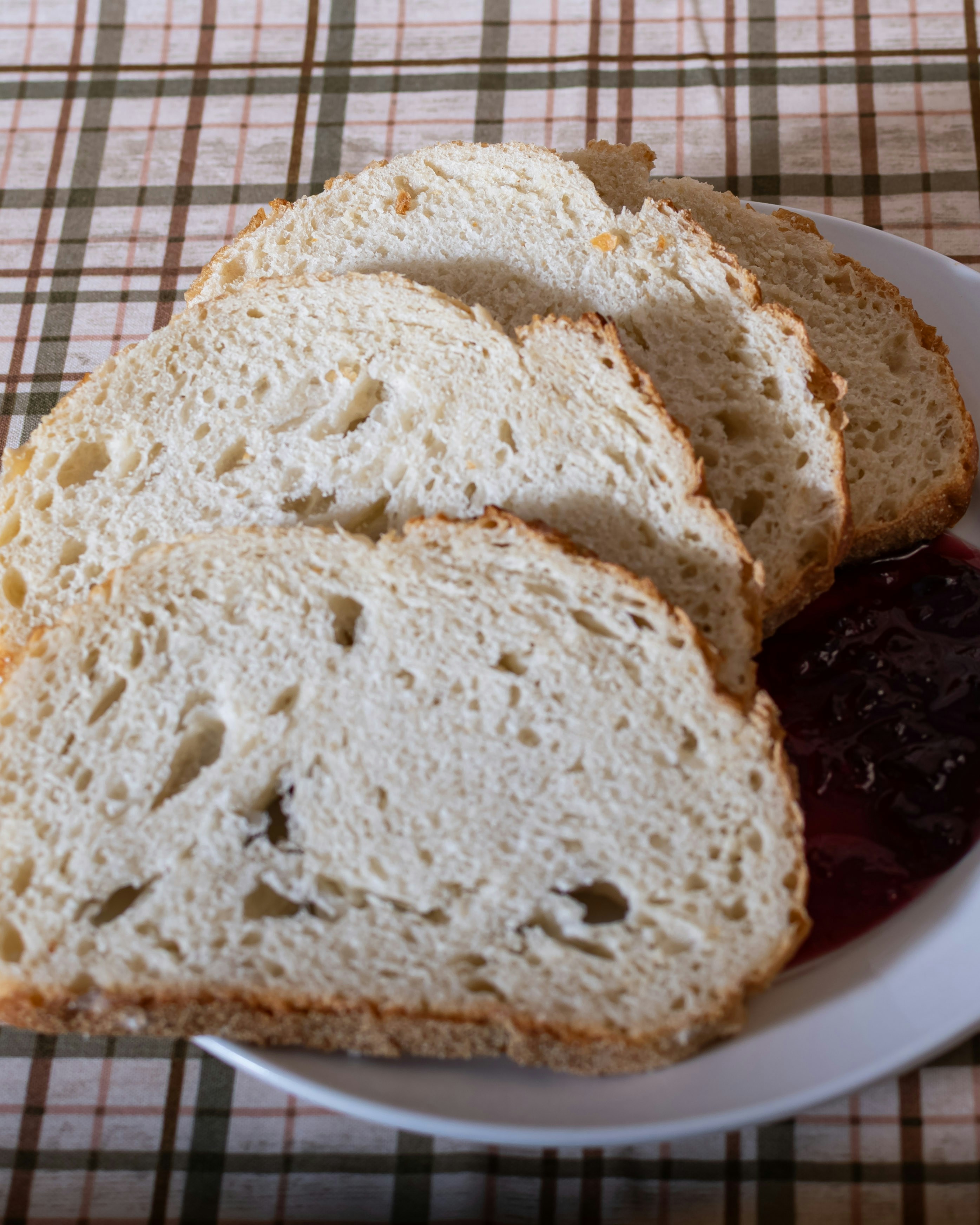 Slices of artisan bread with jam on a plate