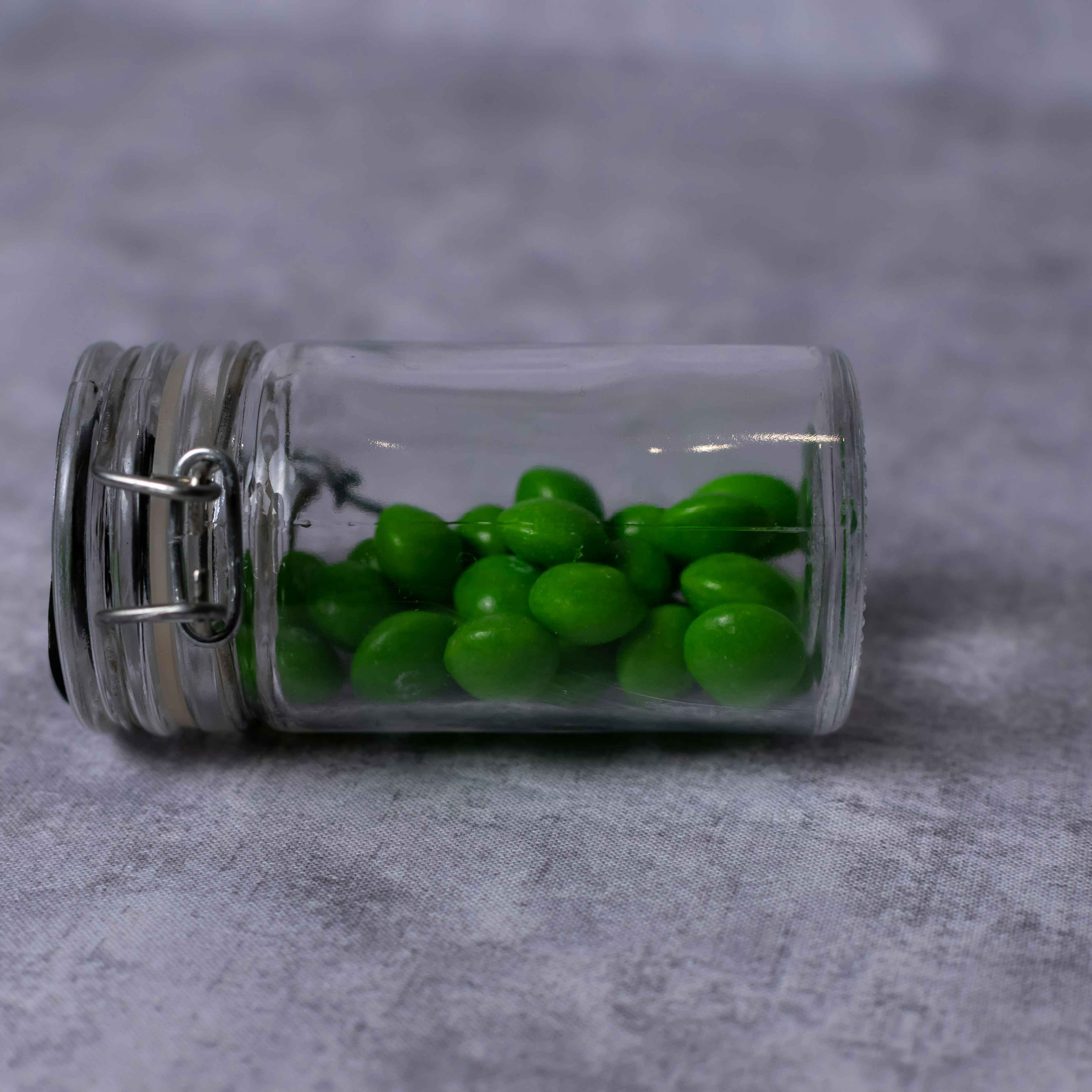 Green candies in a small glass jar
