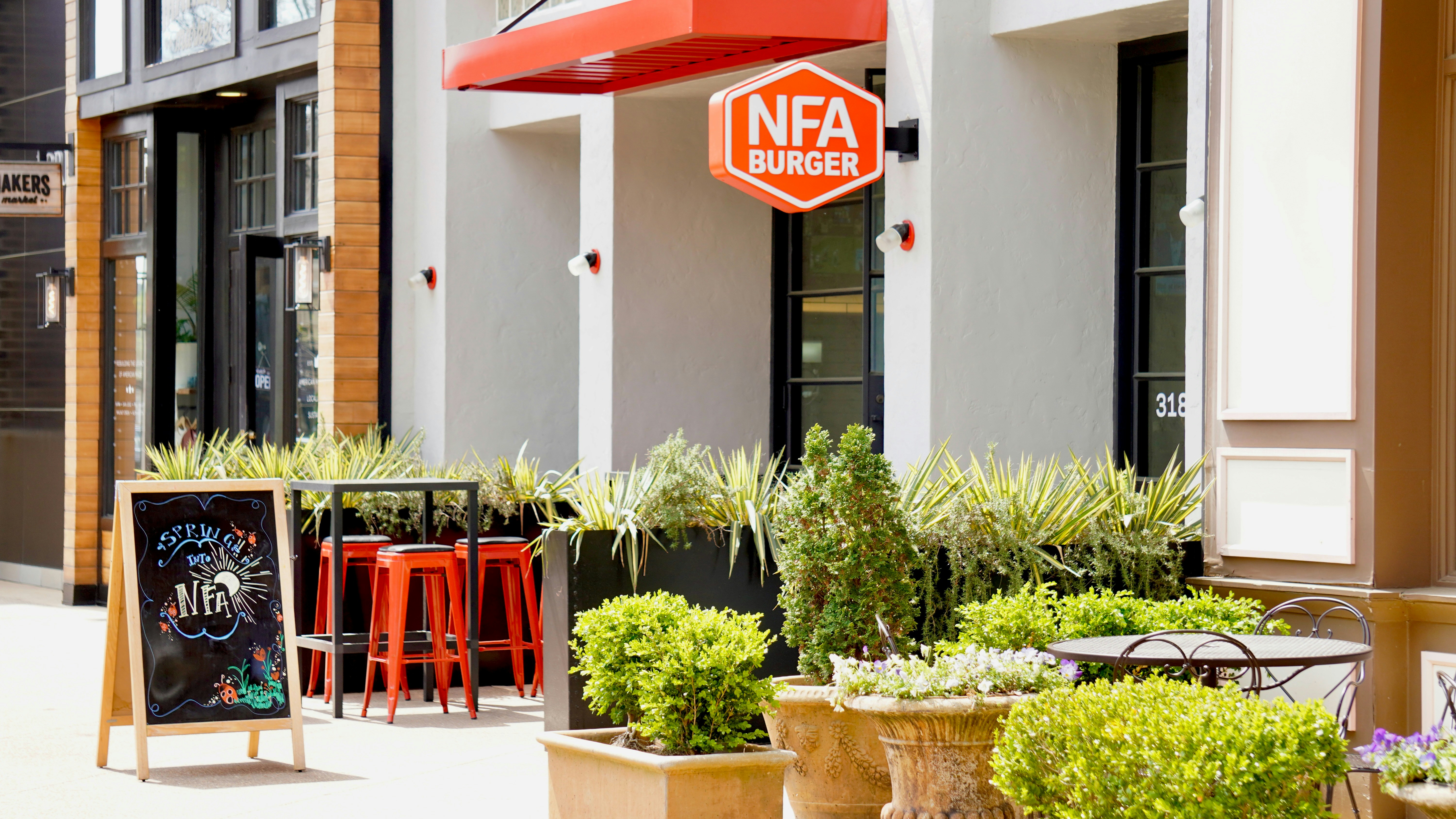 Restaurant exterior with outdoor seating and plants