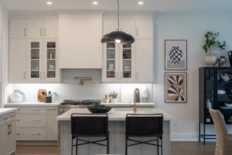 Modern kitchen with island and pendant light.
