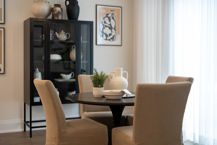 Dining room with upholstered chairs and a display cabinet