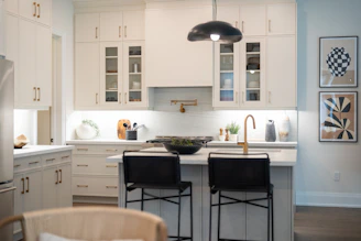 Modern white kitchen with island and bar stools