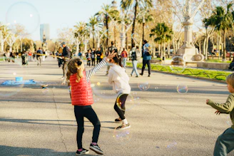Children playing with bubbles in a park