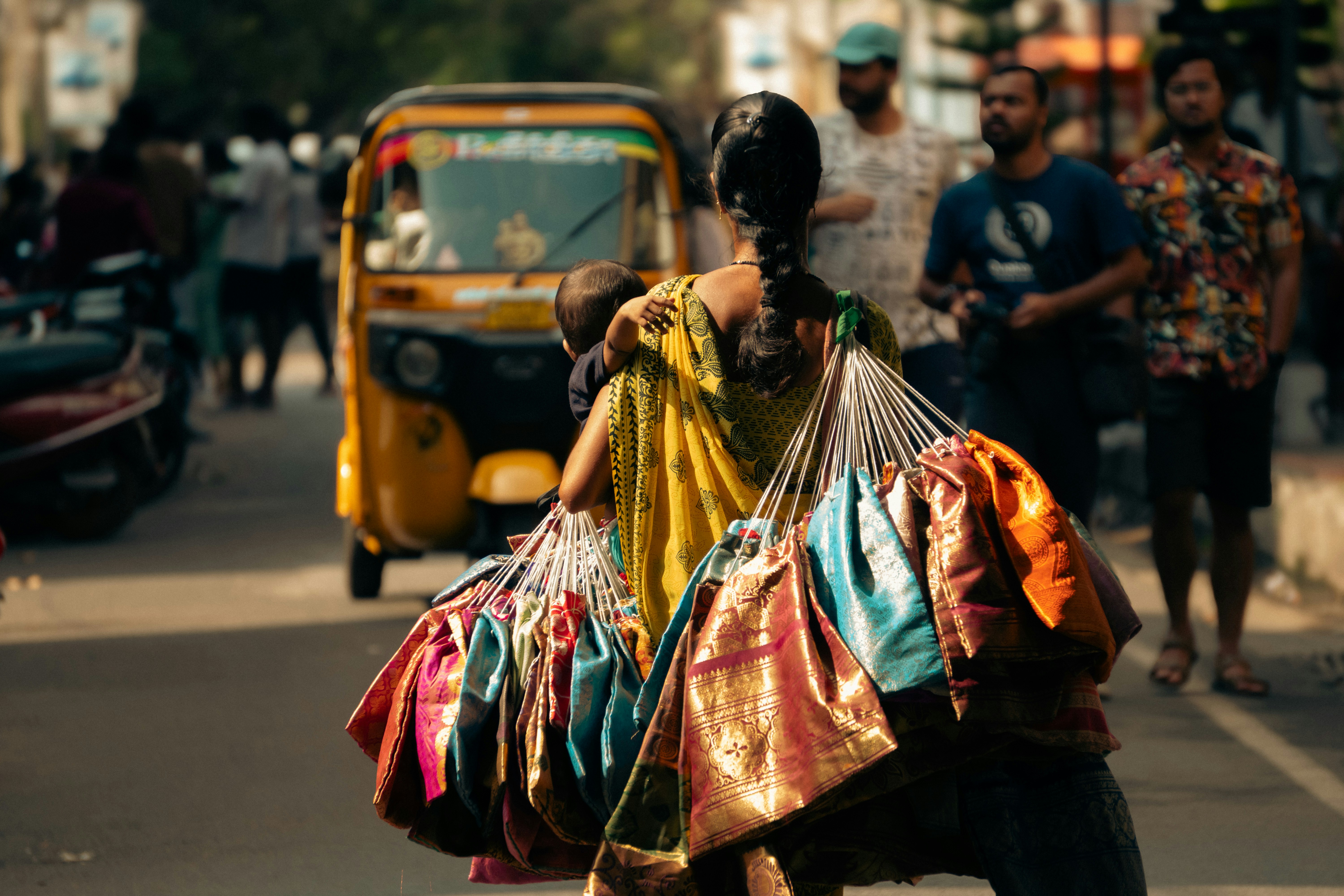 Woman carrying colorful bags on a street
