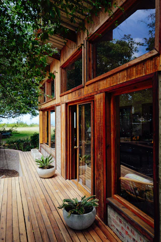 Modern wooden house with large windows and deck