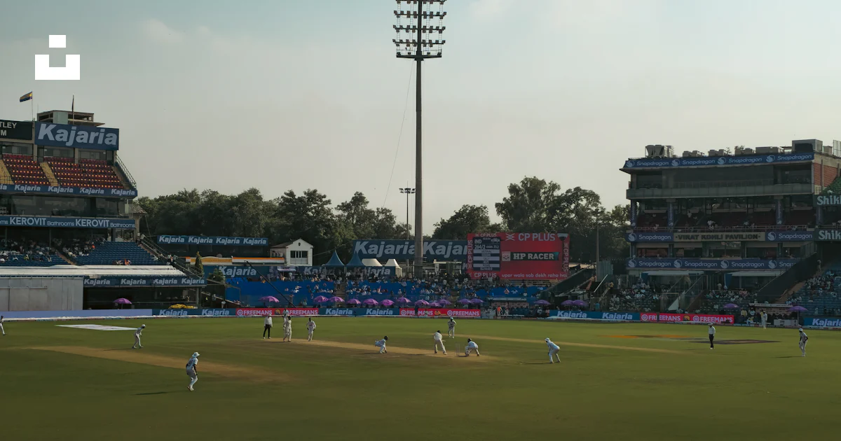 Cricket match in progress at a stadium with spectators. photo – Free ...