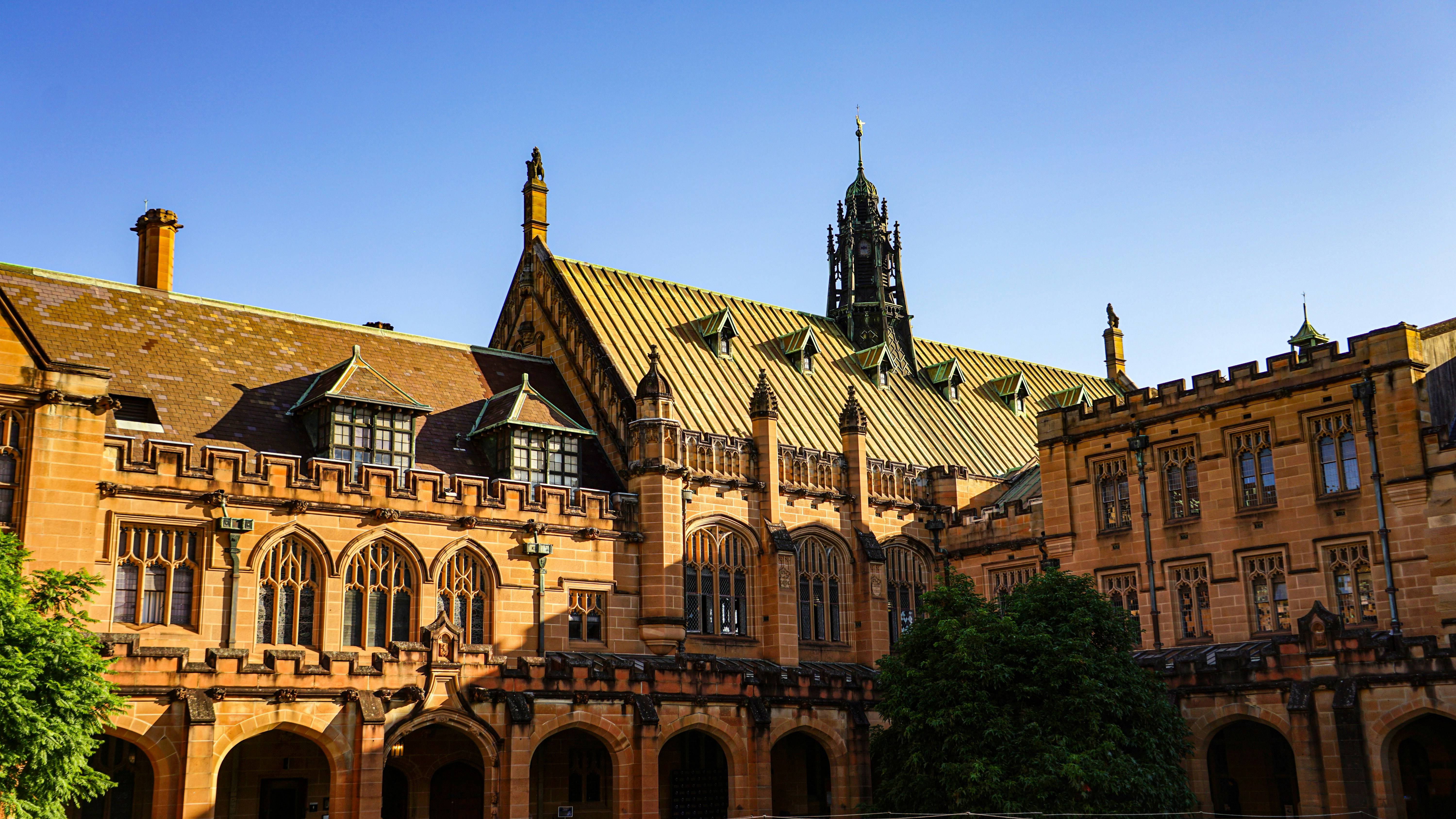 Historic sandstone university building with gothic architecture